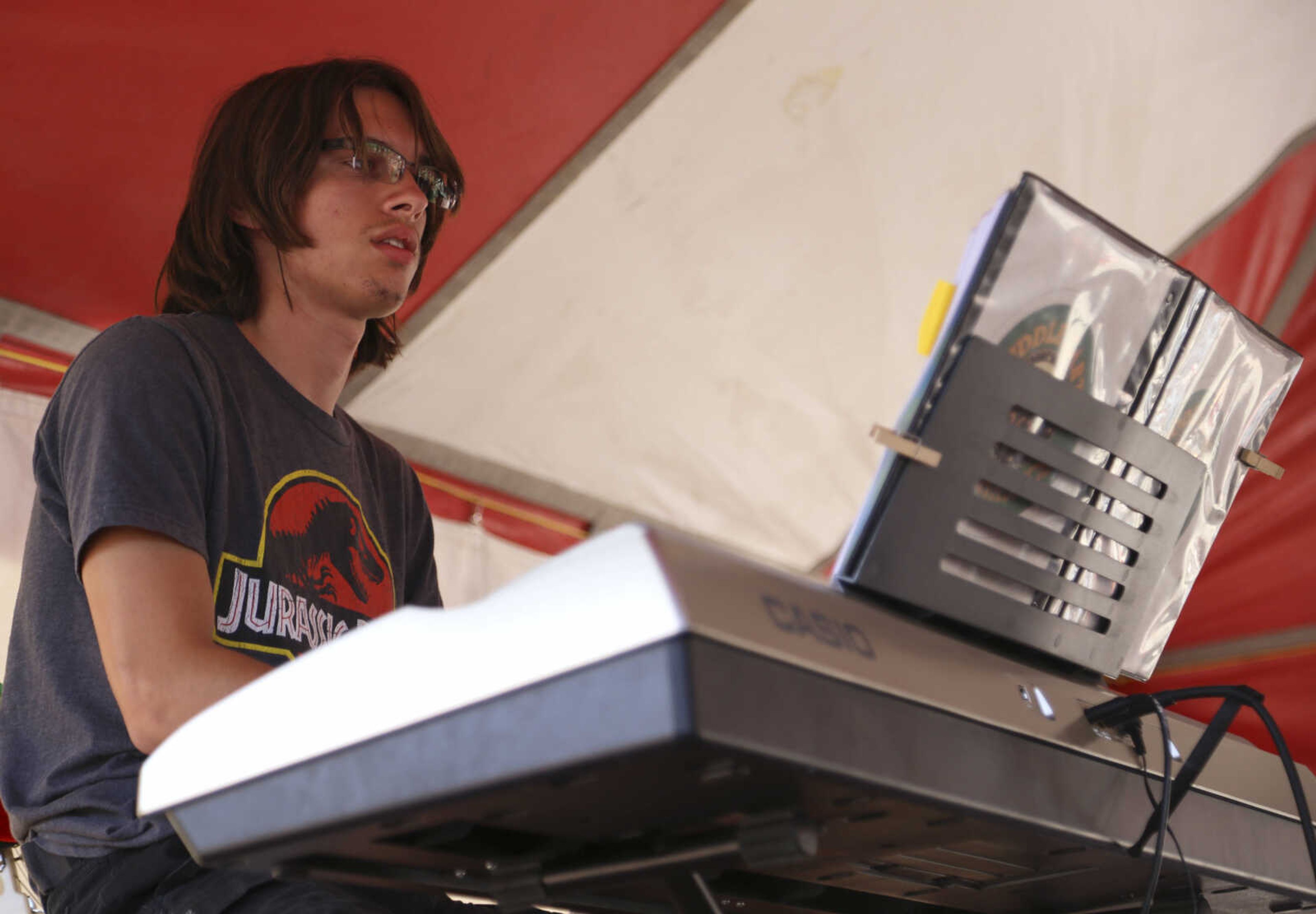 Conrad Criddle plays the theme to Jurassic Park on piano during the St. Mary Cathedral parish picnic on Sunday, August 27, 2017, in Cape Girardeau.