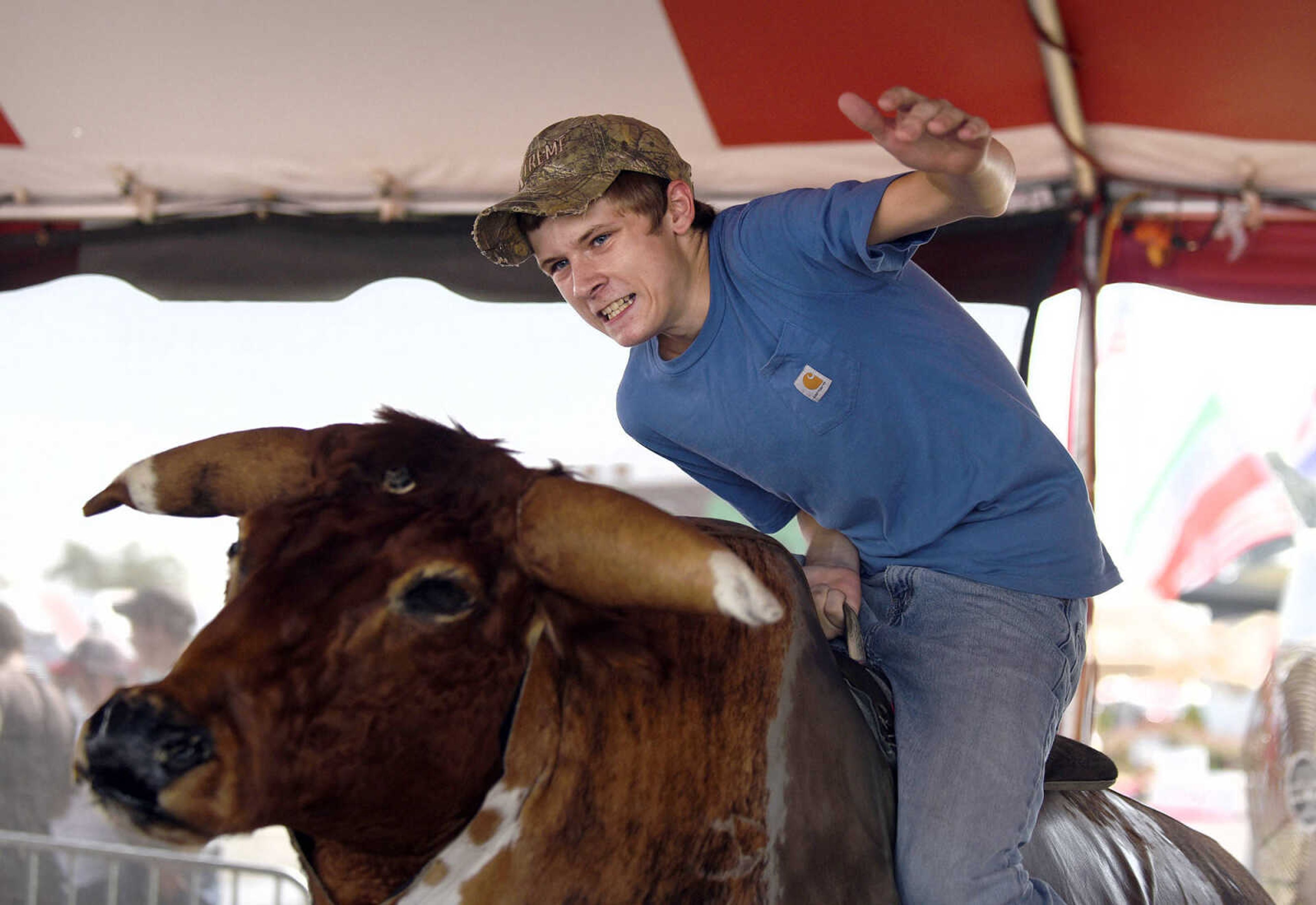 LAURA SIMON ~ lsimon@semissourian.com

People take a shot at the mechanical bull in the 8 Seconds Productions booth at the SEMO District Fair on Friday, Sept. 16, 2016, at Arena Park in Cape Girardeau.