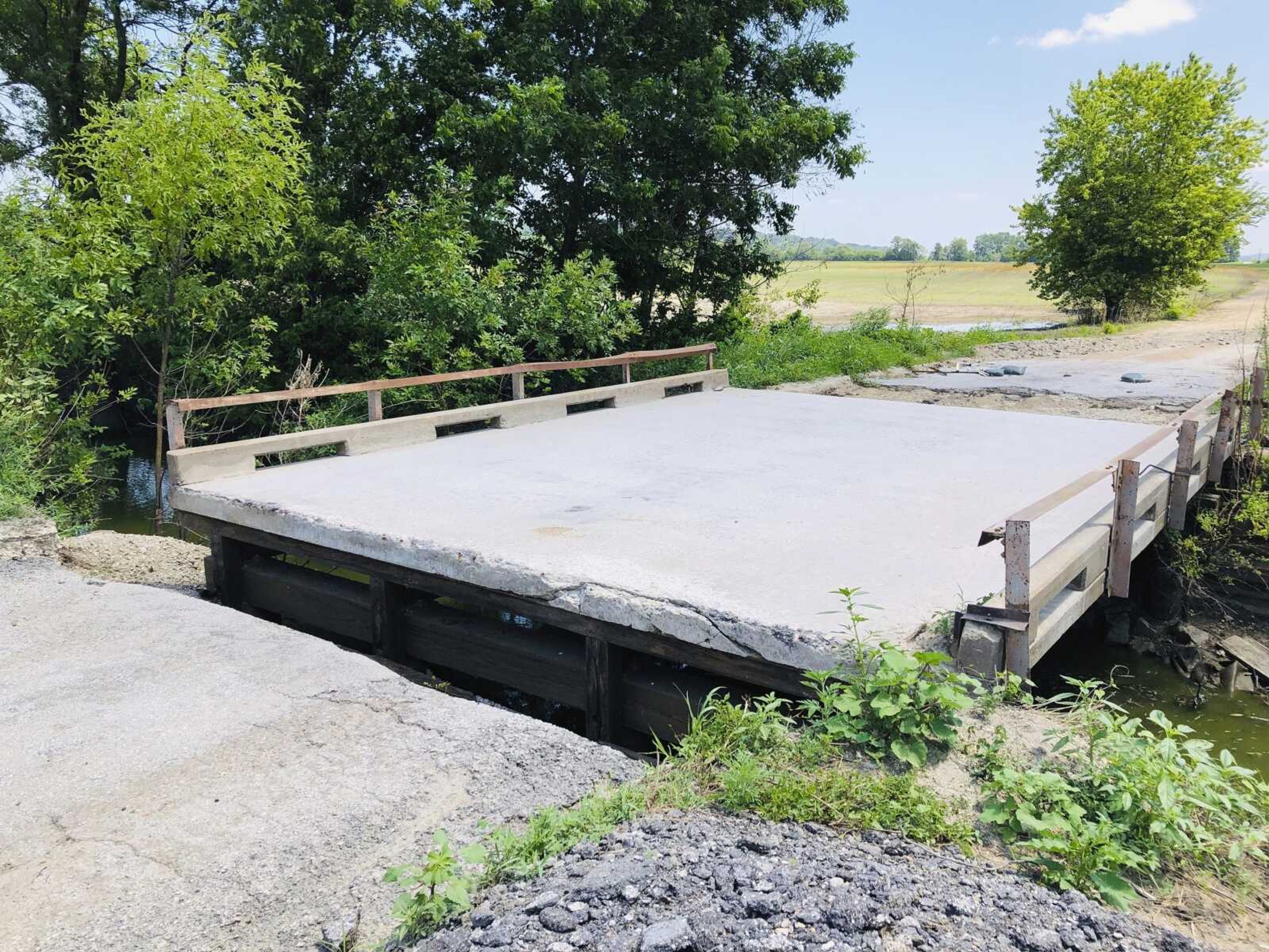 A bridge over a creek near the Missouri River remains inaccessible July 27, well over a month after floodwaters washed out its connection to a rural road, in Callaway County, Missouri. Preliminary assessments show that flooding and storms caused more than $1.1 billion of damage to public infrastructure in 22 states during the first half of 2019, including at least $700 million of damage to roads and bridges.