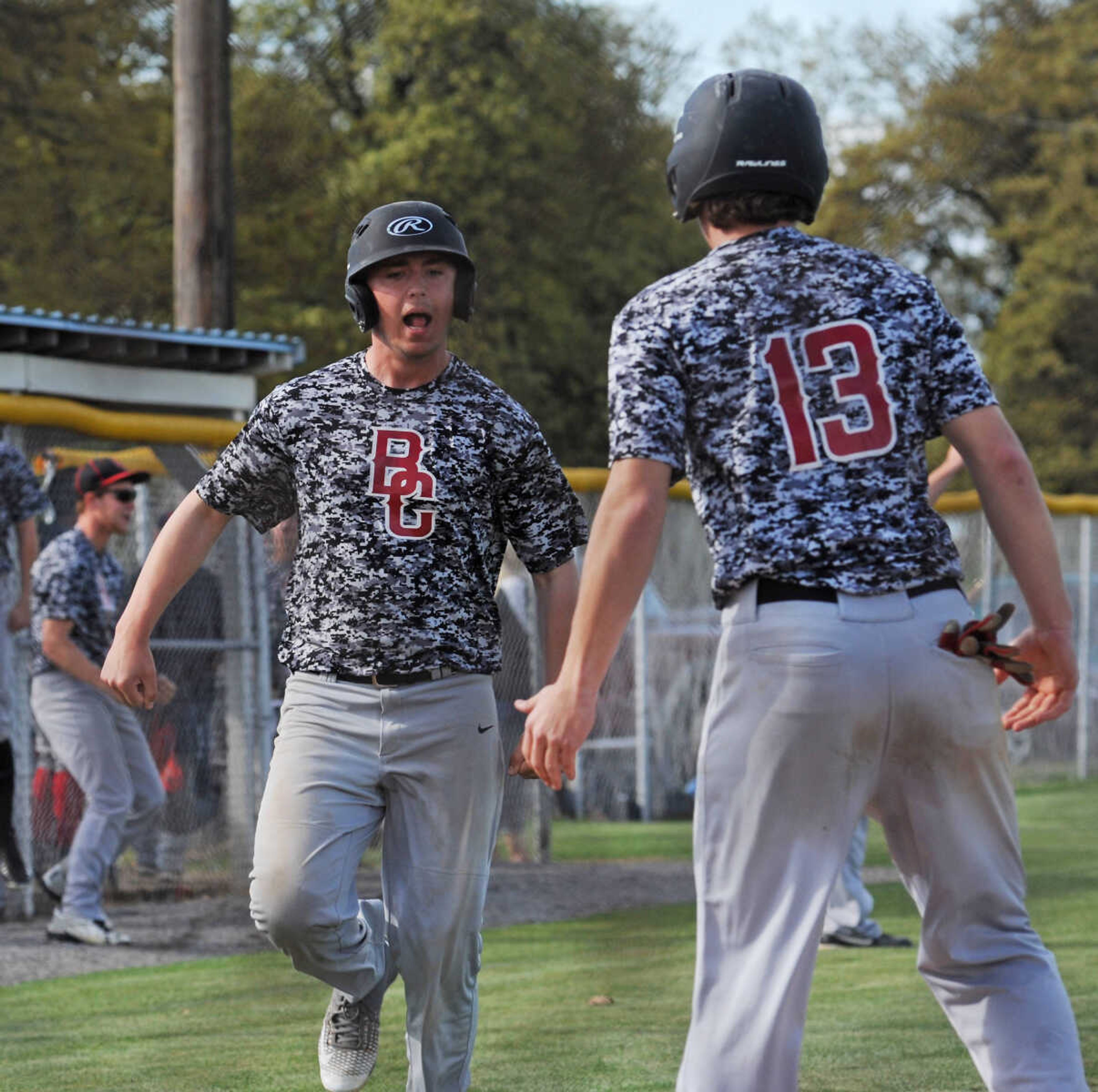 Bell City's Nate Finney celebrates with teammate Austin Hicks at home plate after scoring on a Bobby Wright grand slam in the second inning of the SCAA Conference Tournament championship against Bernie on Thursday, April 21, 2016, in Bernie, Mo. The home run put the Cubs up for good in a 7-5 victory.