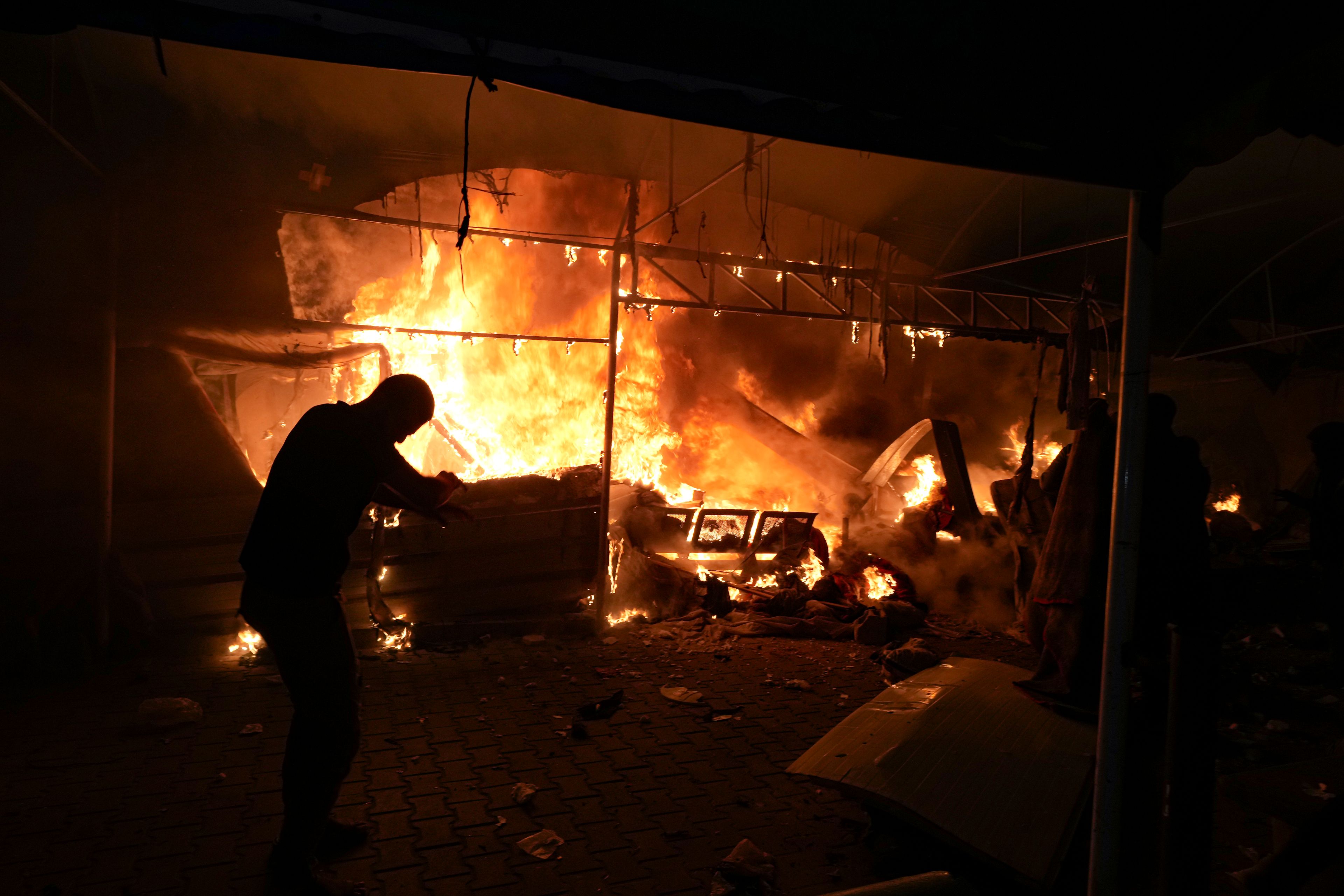 Israeli strike on hospital tent camp kills 4 and ignites a fire that burns dozens