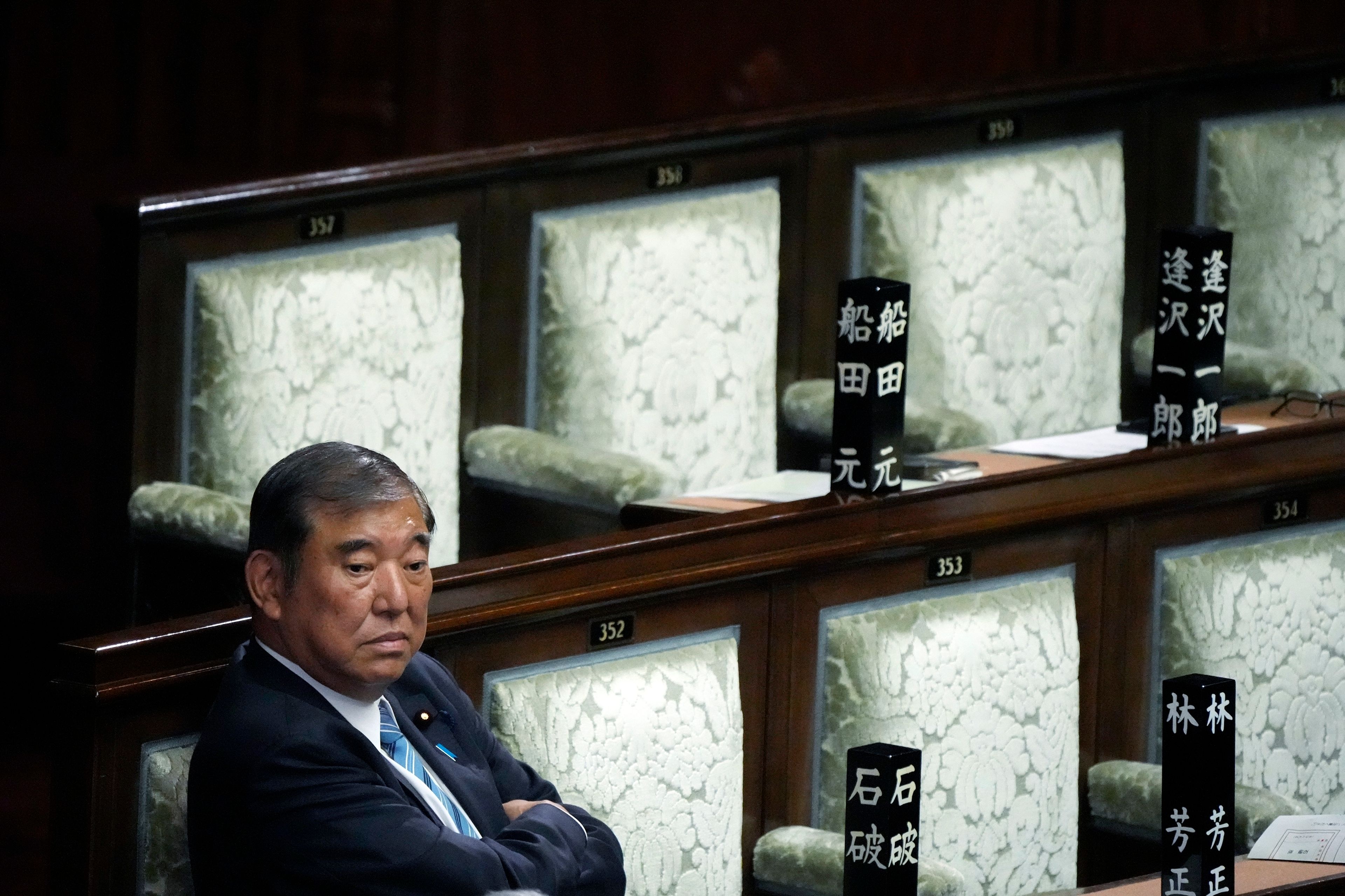 Japanese Prime Minister Shigeru Ishiba waits after the first vote for a new prime minister at a special parliamentary session of the lower house Monday, Nov. 11, 2024, in Tokyo. (AP Photo/Eugene Hoshiko)