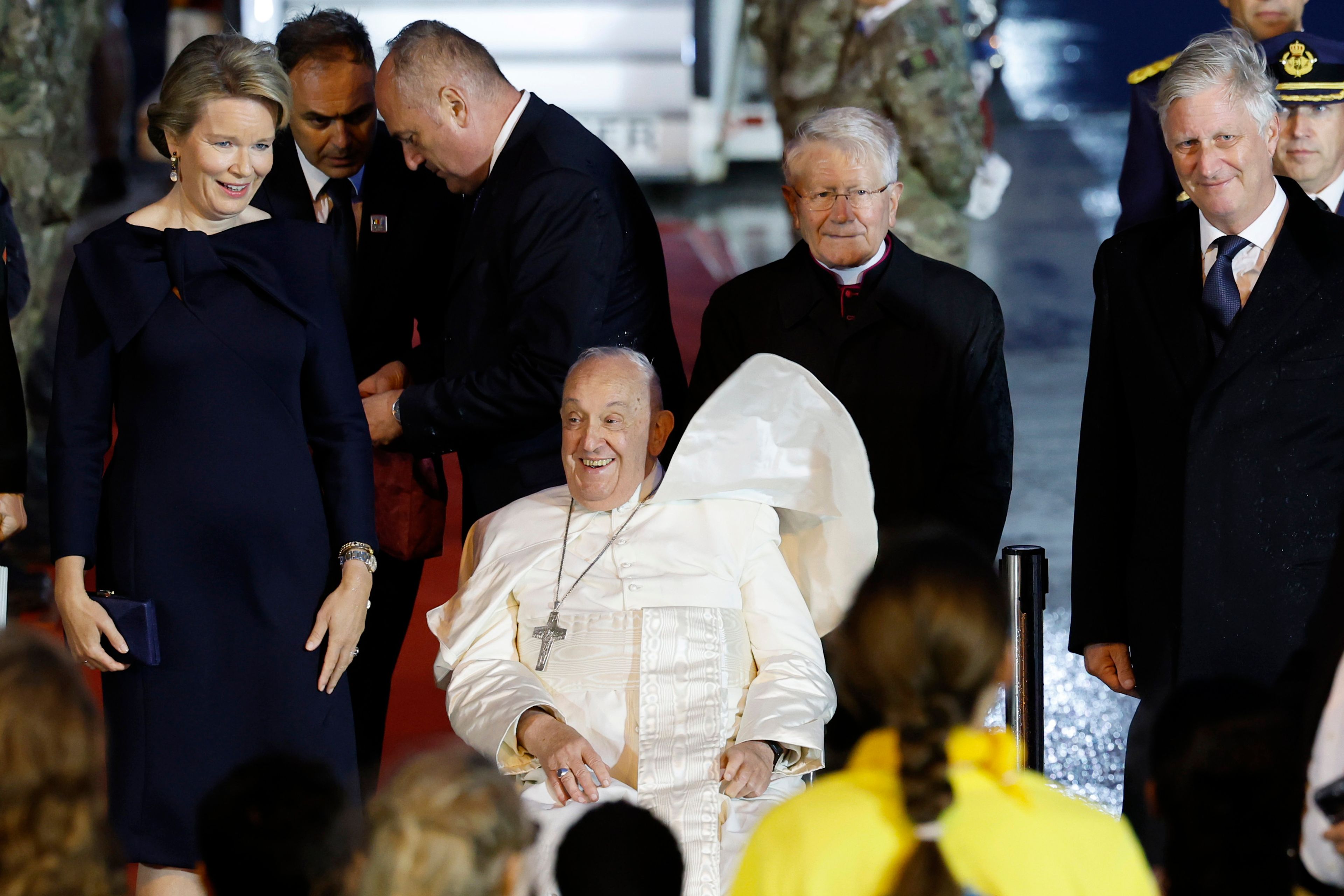 Pope Francis arrives flanked by Queen Mathilde of Belgium and King Philippe of Belgium, at Melsbroek air base in Steenokkerzeel, near Brussels, on the first day of his four-day visit to Luxembourg and Belgium, Thursday, Sept. 26, 2024. (AP Photo/Geert Vanden Wijngaert)