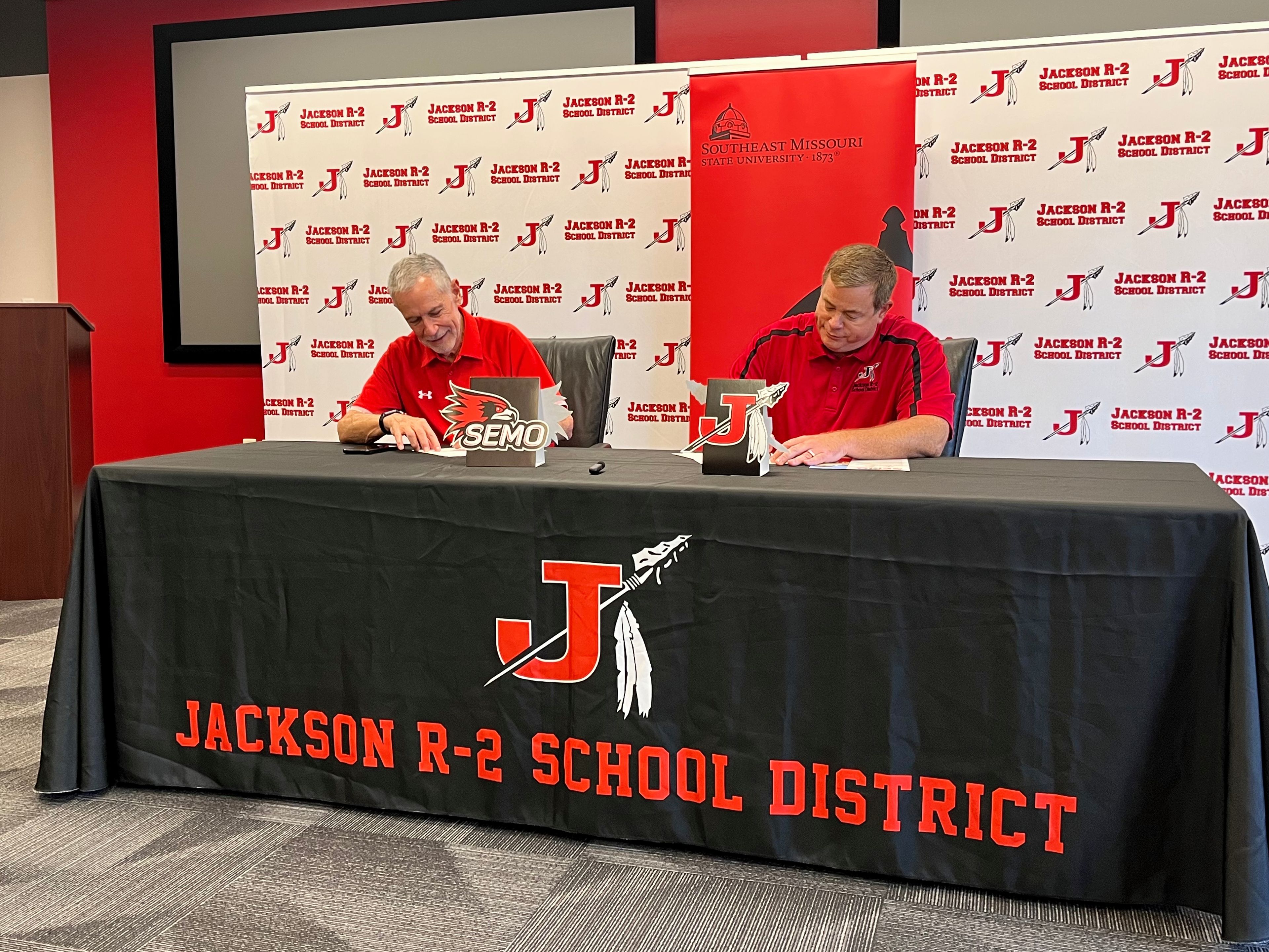 Southeast Missouri State University president Carlos Vargas, left,  and Jackson School District superintendent Scott Smith sign a partnership agreement during a news conference Friday, Aug. 30, at Jackson High School in Jackson.