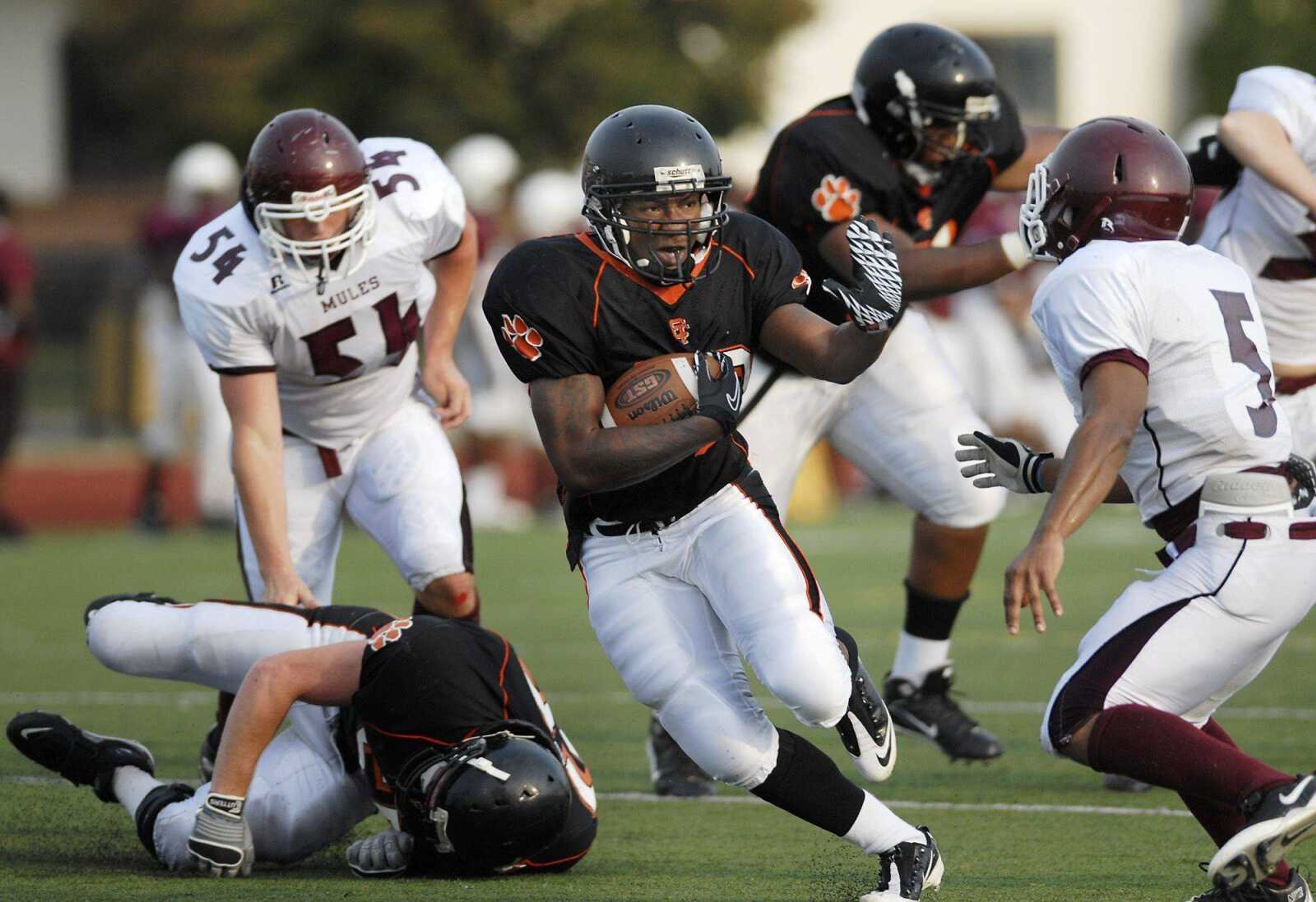 Central running back Keilon Moore tries to avoid Poplar Bluff's Pete Bryant on a run during Friday's jamboree in Farmington, Mo.