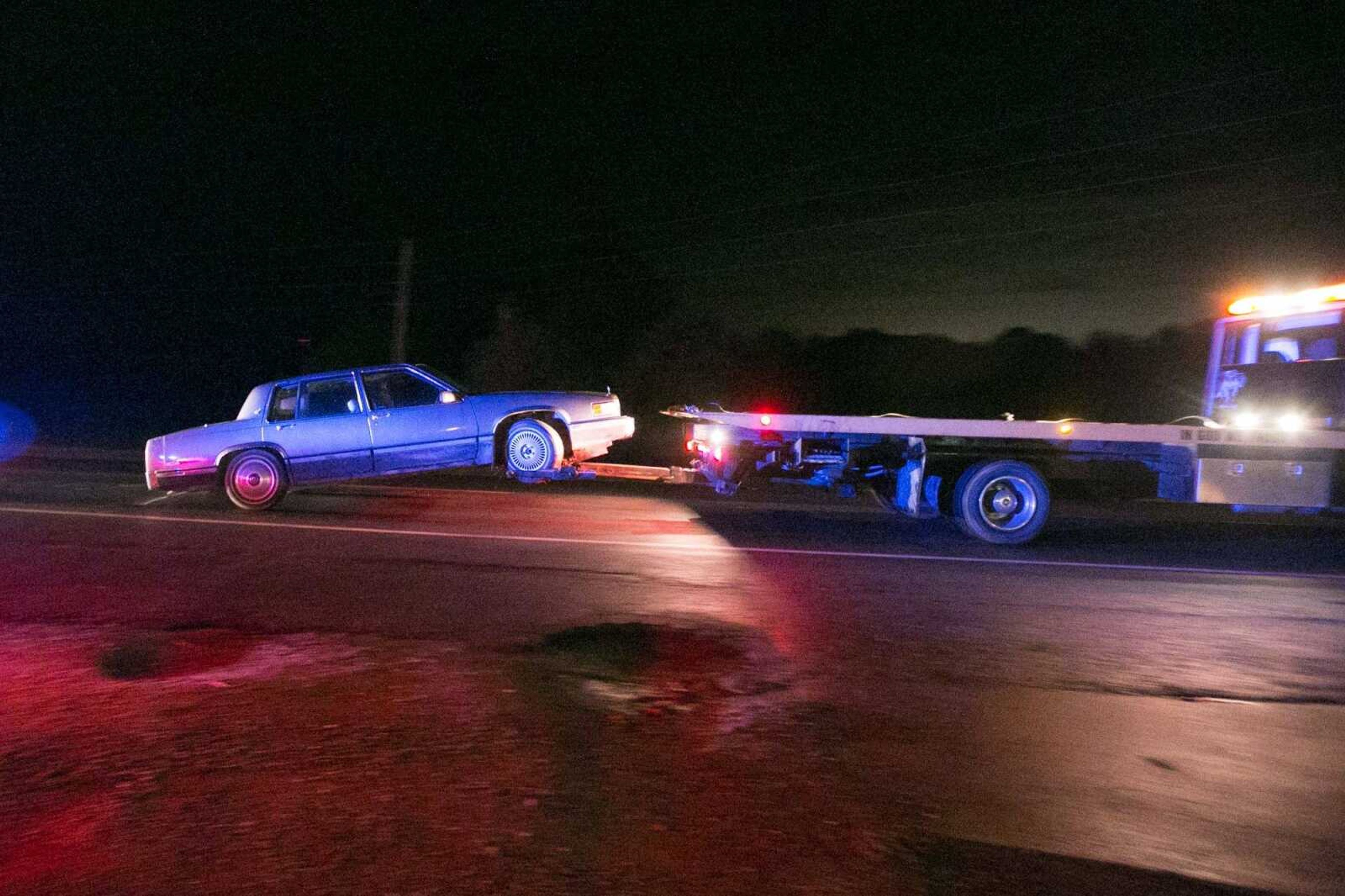 A car is towed away from the scene of an officer-involved shooting Friday on Highway 177 near the Lil' Country Store in Jackson.