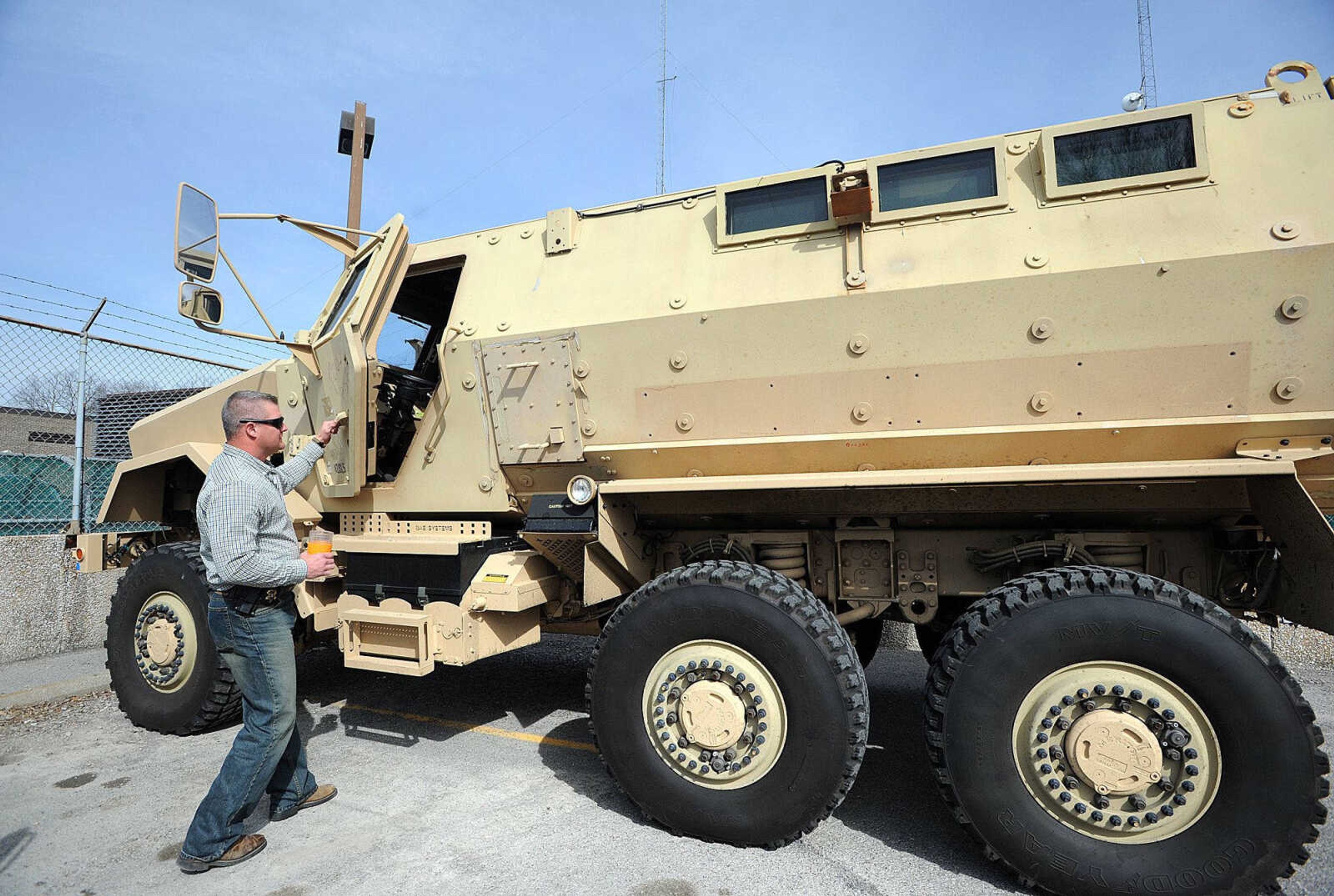 Lt. Chris Hull with the Cape Girardeau County Sheriff's Department, opens the 700-pound driver's side door to the department's new mine-resistant ambush protected vehicle Friday afternoon. (Laura Simon)