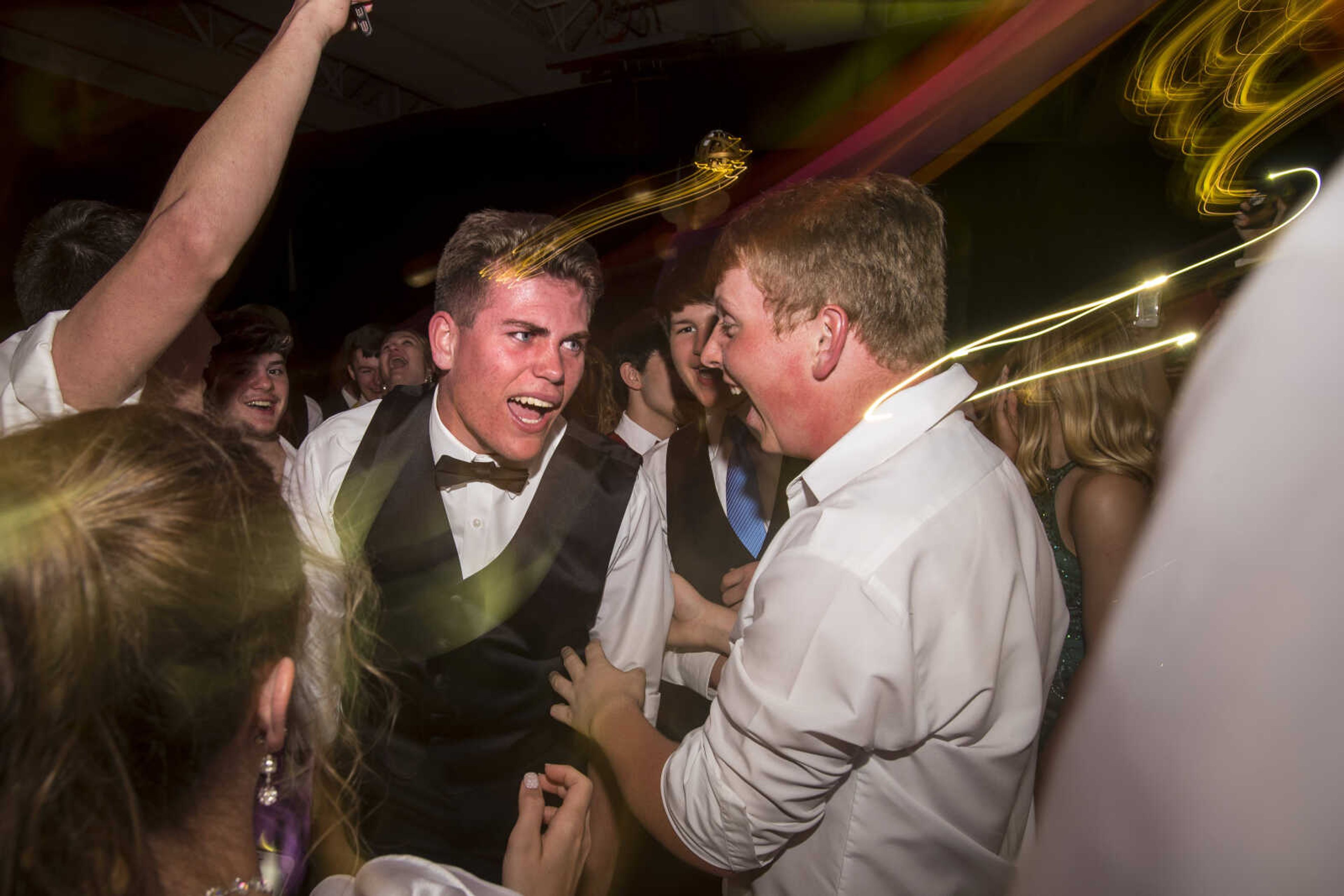 Peyton Eftink, left, dances rowdily after hearing the opening to Journey's "Don't Stop Believin'" during prom Saturday, April 6, 2019, at Kelly High School in Benton.