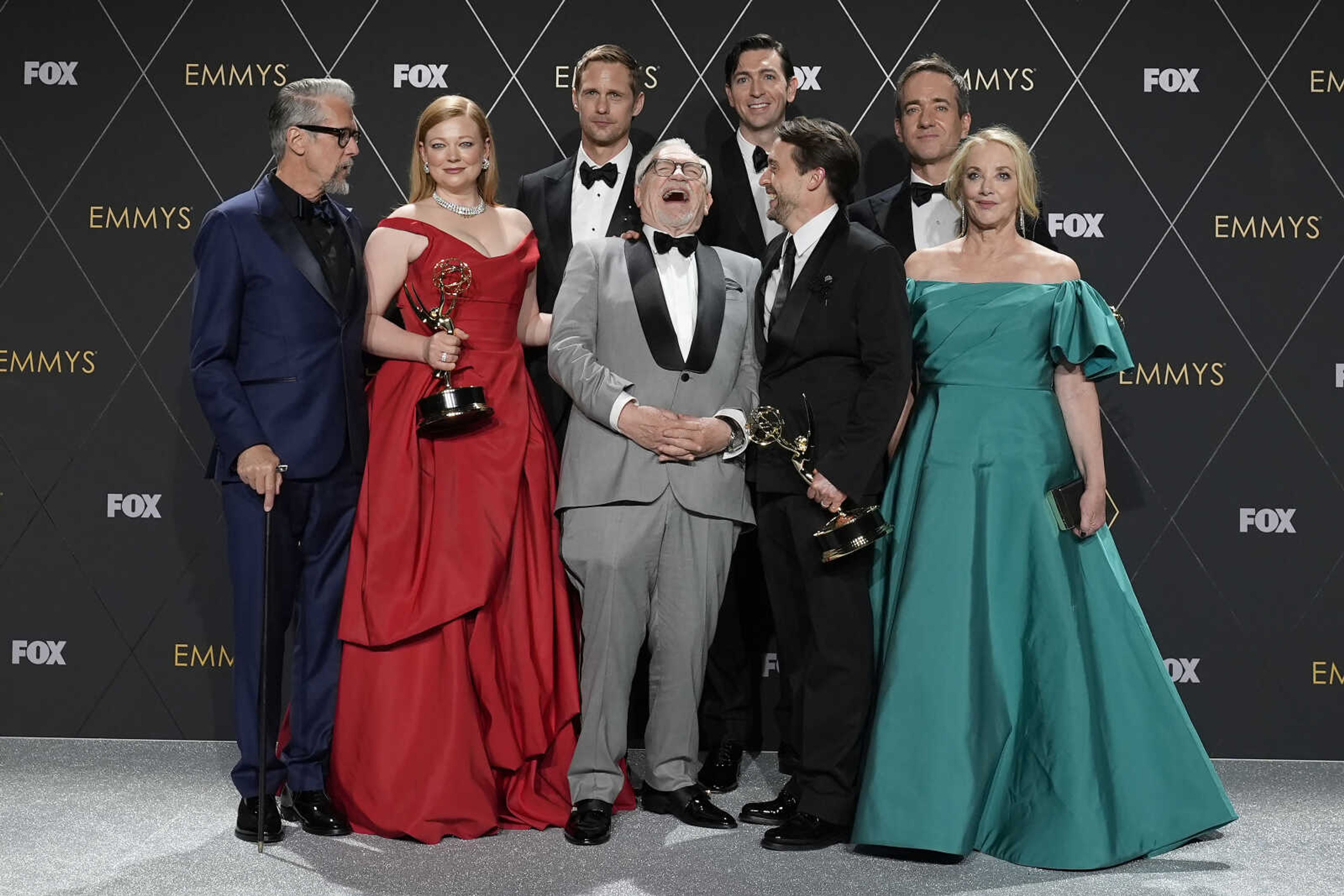 Alan Ruck, from left, Sarah Snook, Alexander Skarsgard, Brian Cox, Nicholas Braun, Kieran Culkin, Matthew Macfayden and J. Smith-Cameron, winners of the award for outstanding drama series for "Succession", pose in the press room during the 75th Primetime Emmy Awards on Monday at the Peacock Theater in Los Angeles.