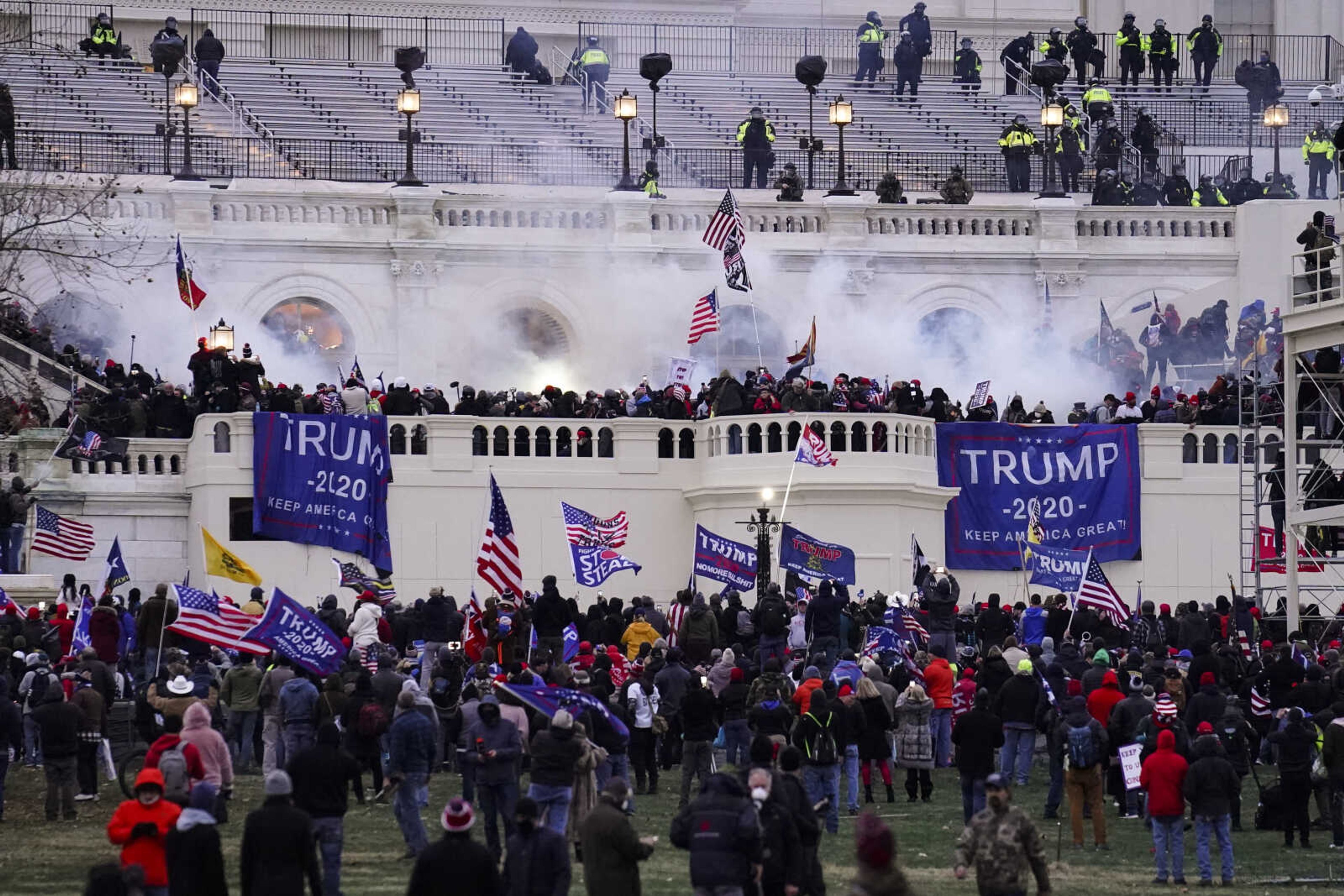 FILE - Violent rioters loyal to President Donald Trump storm the Capitol in Washington on Jan. 6, 2021. Lawsuits playing out in two states this week seeking to keep former President Donald Trump off the ballot rely on a constitutional clause barring those from office who "have engaged in insurrection." One challenge has become clear during the hearings in Colorado and Minnesota: No one can agree on how to define an insurrection. (AP Photo/John Minchillo, File)