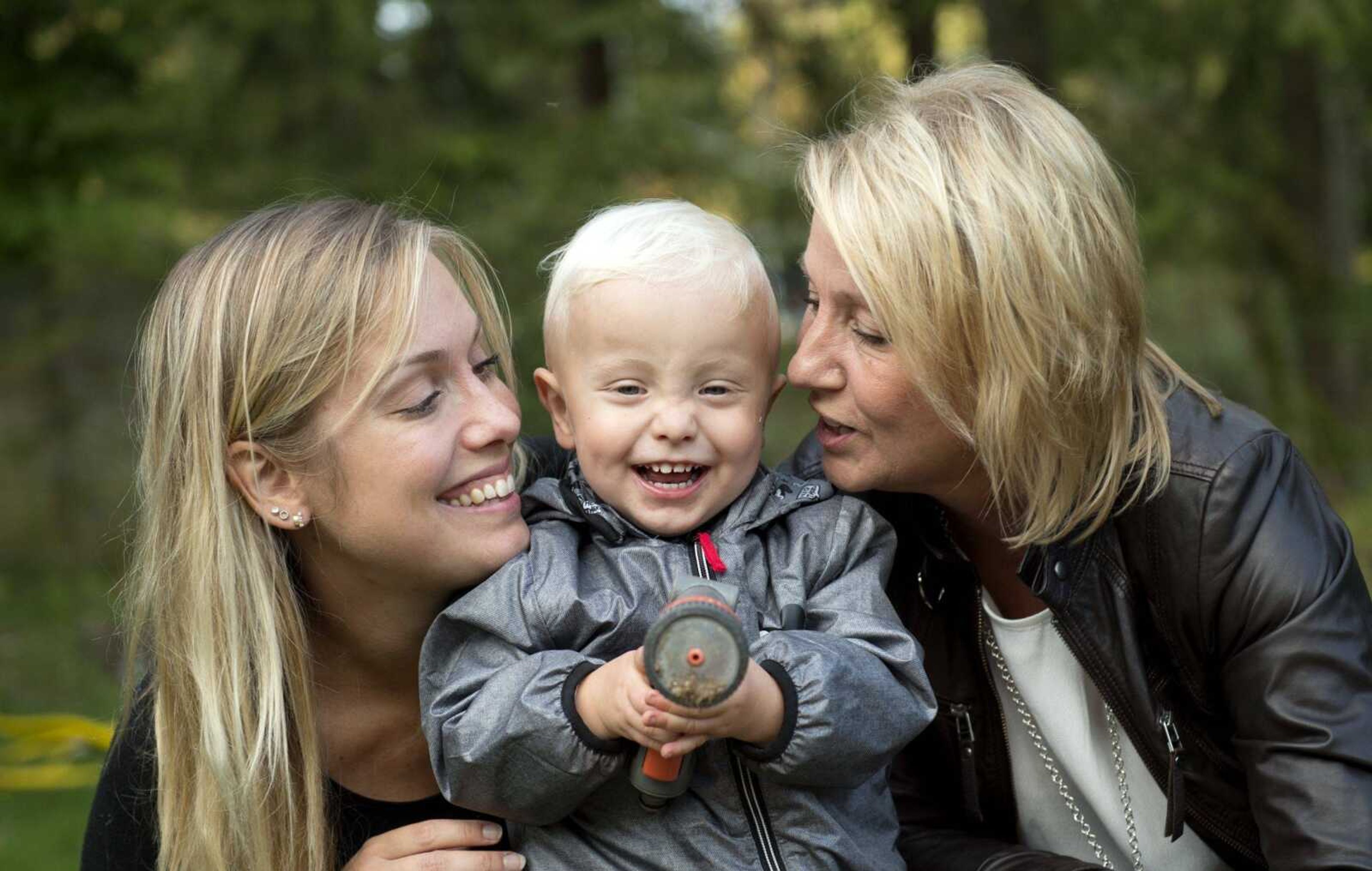 Albin's mother, Emelie Eriksson, left, smiles as she poses for a photo Sept. 20 with her son and her mother, Marie, right, outside her home in Bergshamra, Sweden. Eriksson was the first woman to have a baby after receiving a womb transplant from her mother.