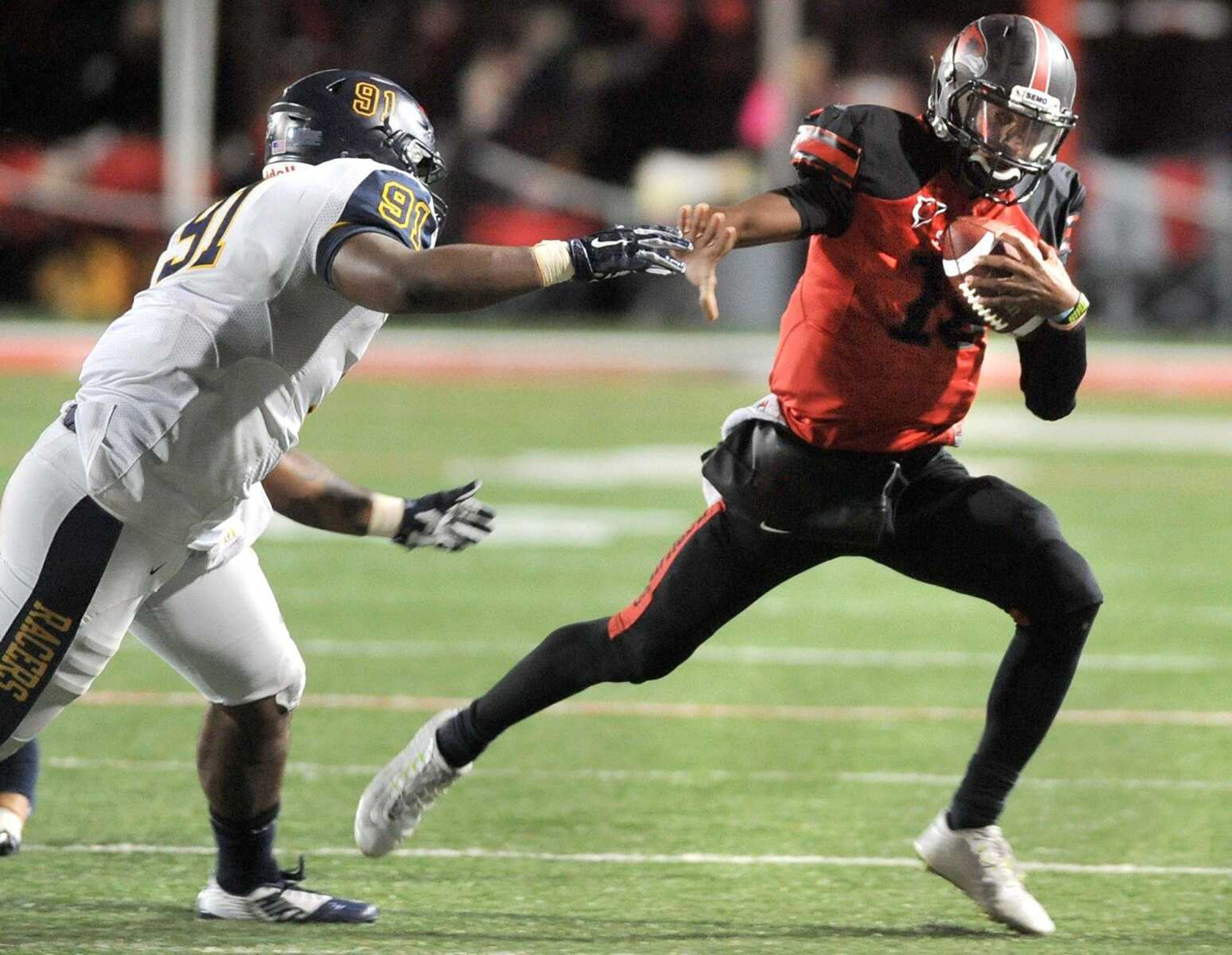 Southeast Missouri State quarterback Dante Vandeven carries away from Murray State's Bishop Woods during the second quarter Saturday at Houck Stadium. Southeast won 27-10. (Fred Lynch)