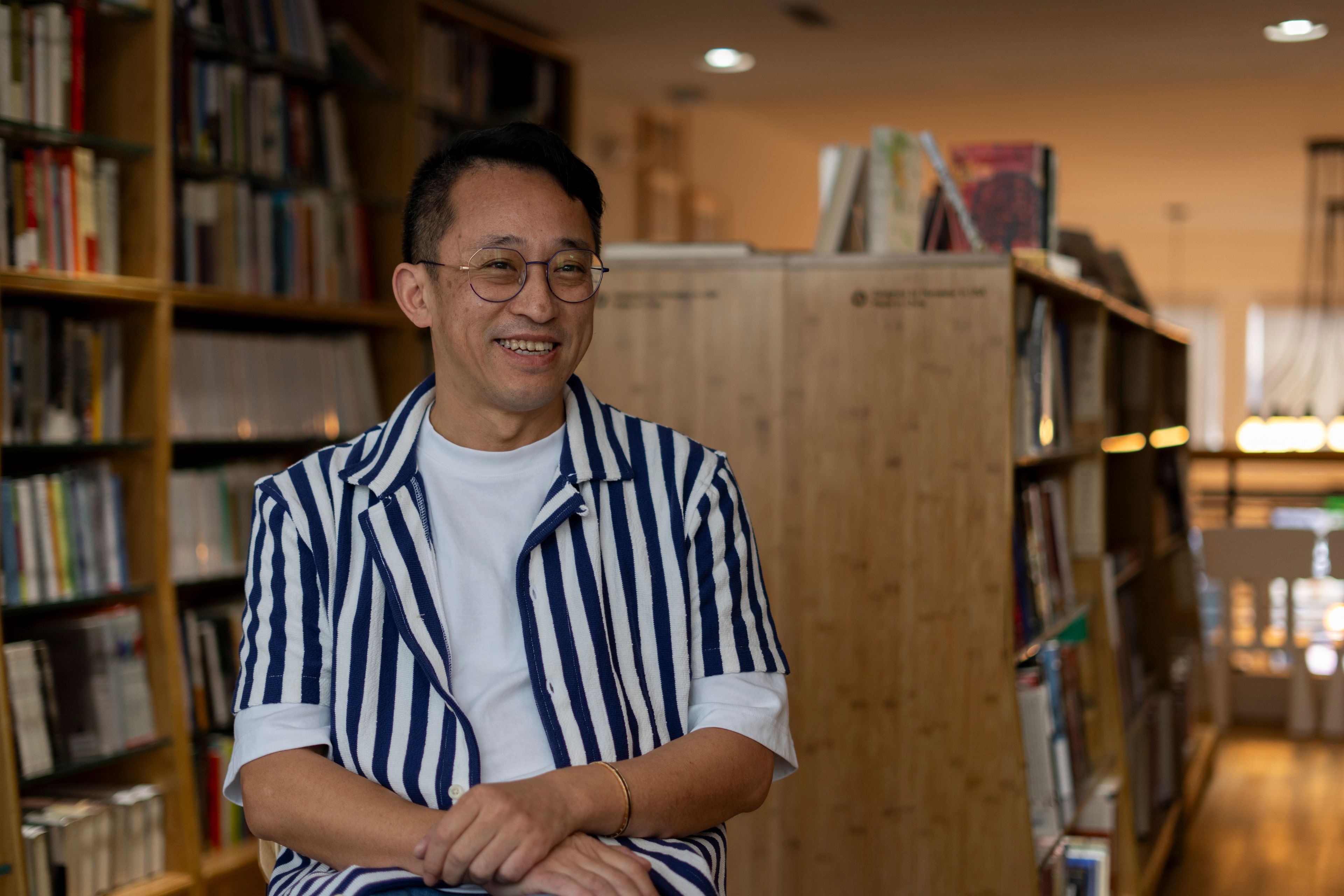 Yu Miao, owner of JF Books, smiles as he speaks to The Associated Press in his bookstore in Washington, Thursday, Oct. 3, 2024. (AP Photo/Ben Curtis)