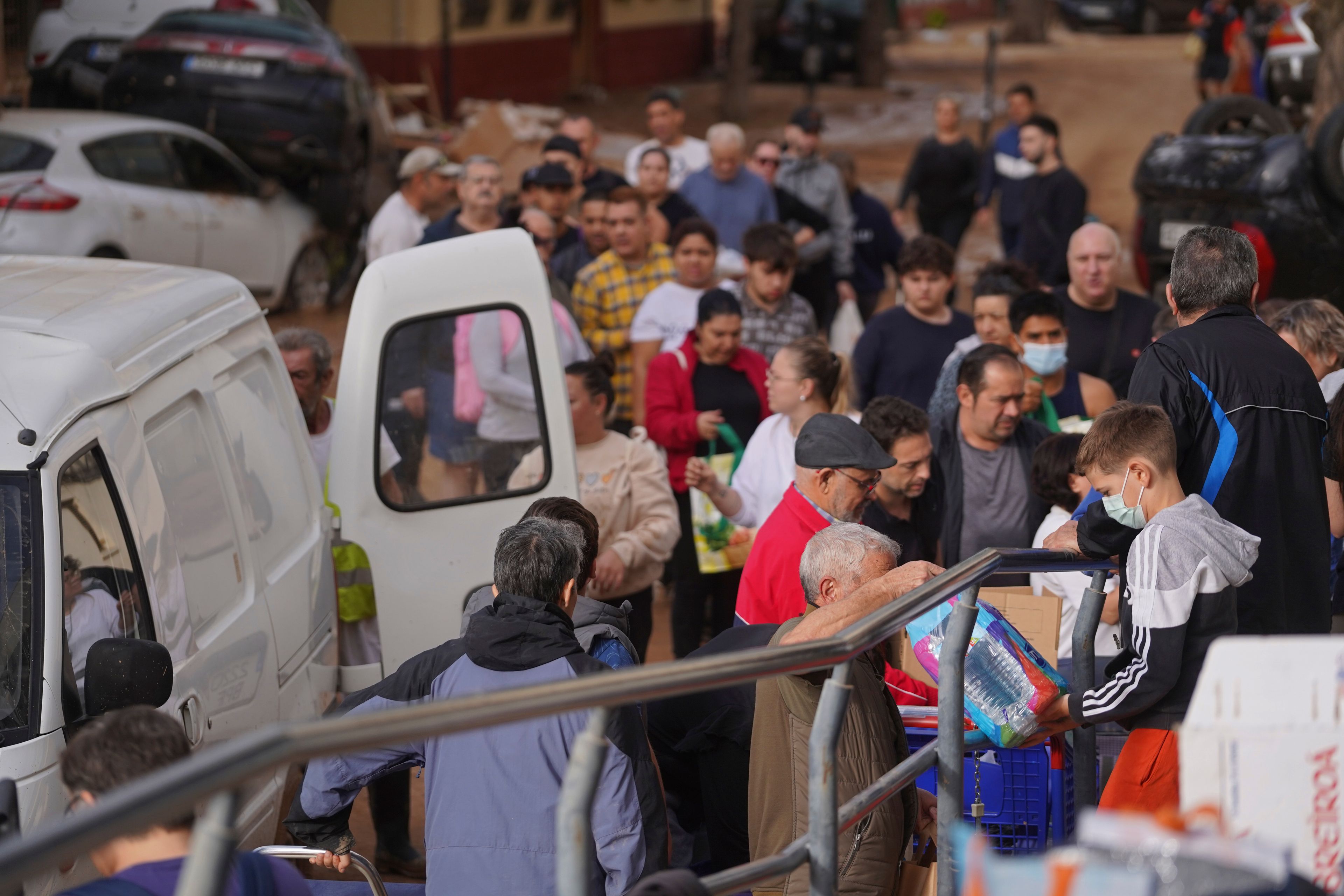 Food and water are given out to residents after floods in Massanassa, just outside of Valencia, Spain, Saturday, Nov. 2, 2024. (AP Photo/Alberto Saiz)