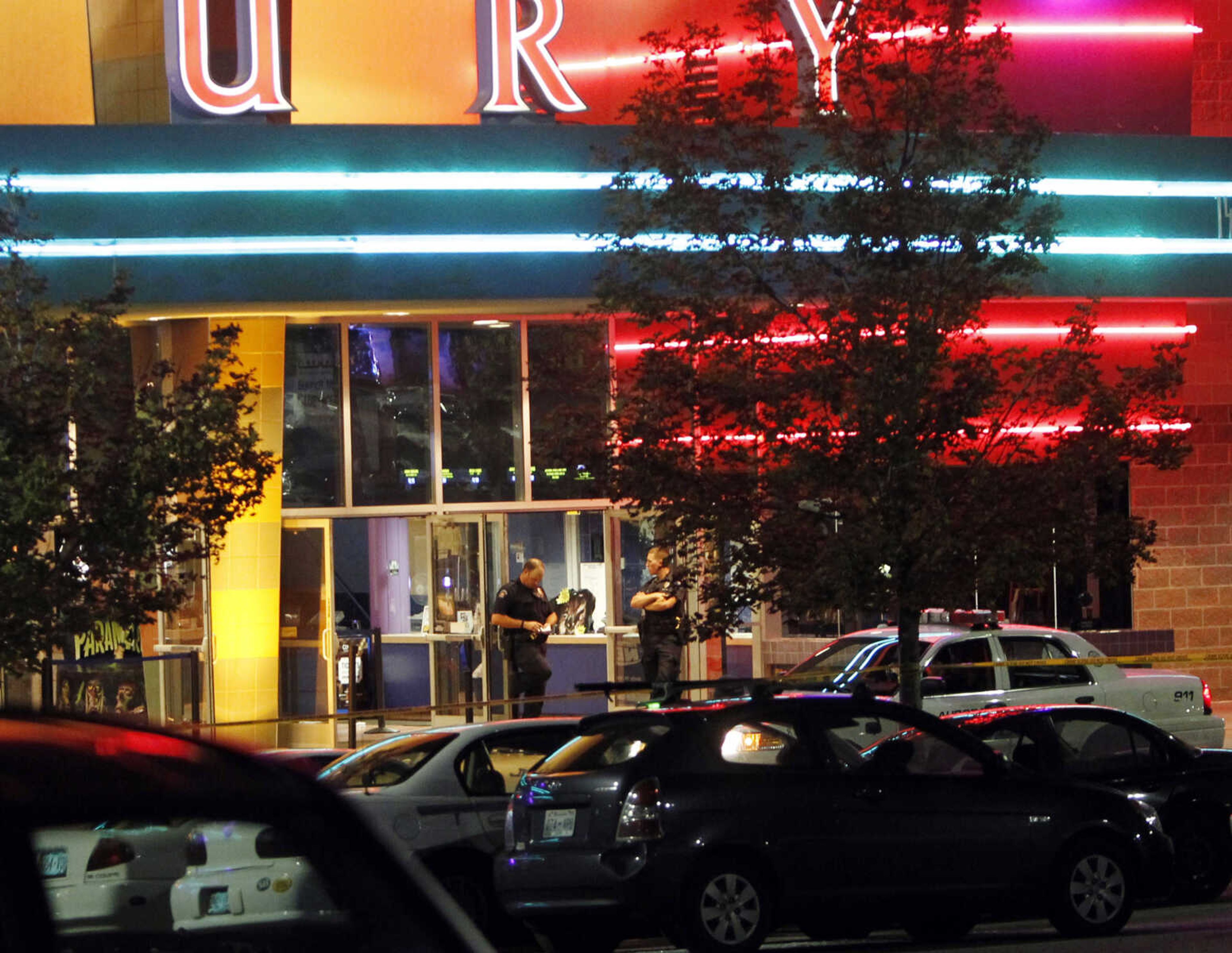 Police are pictured outside of a  Century 16 movie theatre where as many as 14 people were killed and many injured at a shooting during the showing of a movie at the in Aurora, Colo., Friday, July 20, 2012. (AP Photo/Ed Andrieski)