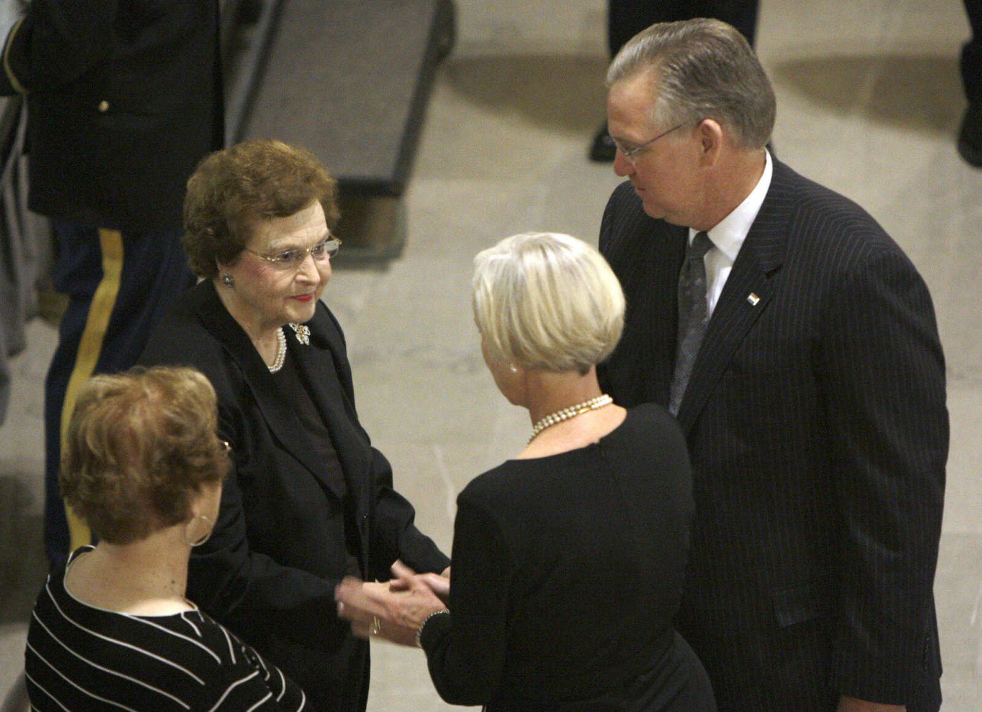 Former Missouri first lady Betty Hearnes, top left, is greeted by Gov. Jay Nixon, top right, and first lady Georganne Nixon as Betty Hearnes' sister, Jane Cooper Stacy, bottom left, looks on during a public viewing for former Gov. Warren Hearnes in the Capitol Rotunda Wednesday, Aug. 19, 2009, in Jefferson City, Mo. Hearnes, who from 1965 to 1973 was the first Missouri governor to serve two full consecutive terms in office, died late Sunday night at the age of 86 at his home in Charleston.(AP Photo/Jeff Roberson)