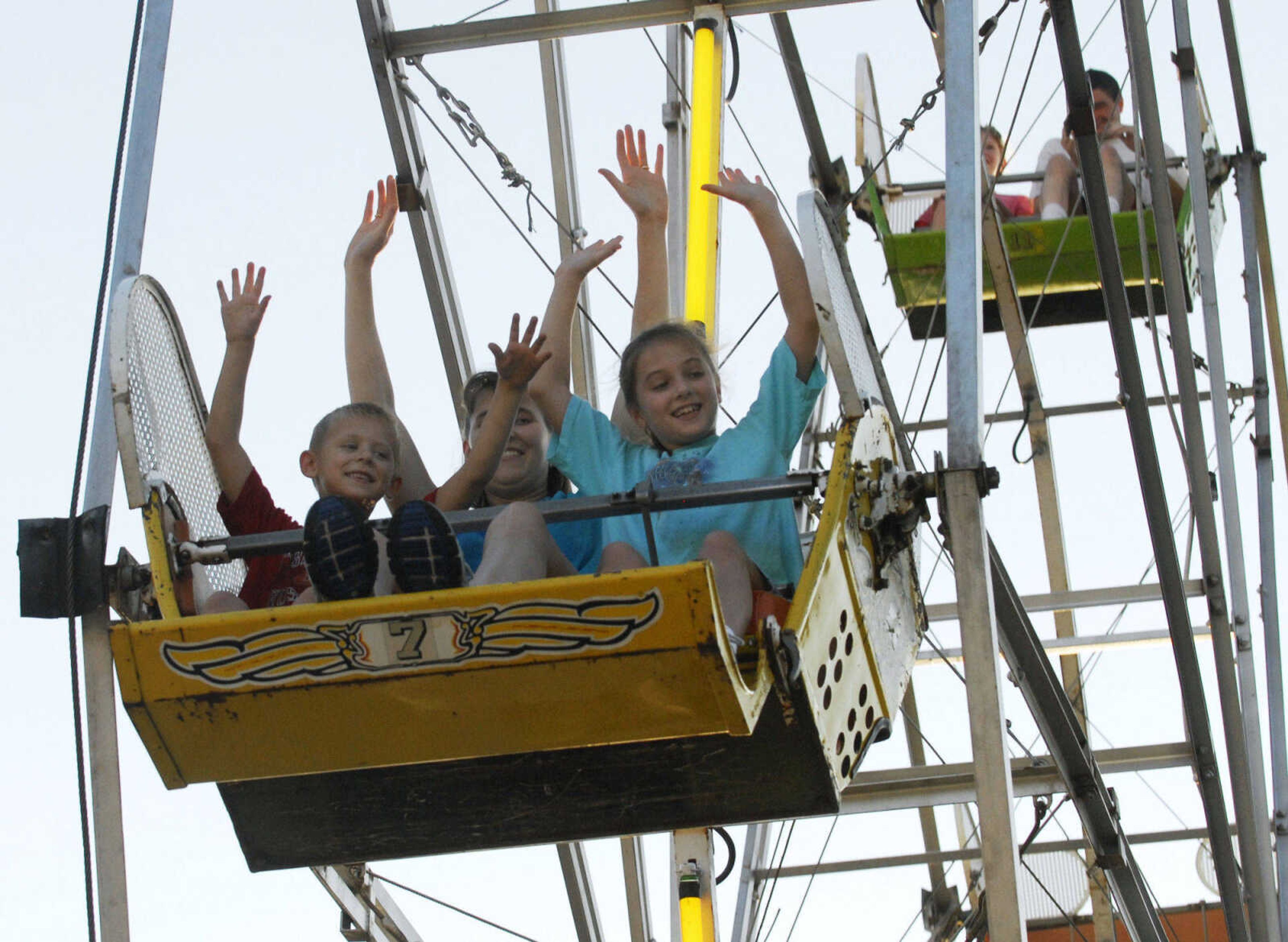 KRISTIN EBERTS ~ keberts@semissourian.com

Drew Roth, 6, mother Andrea Roth, and sister Abby Roth, 8, from left, enjoy the ferris wheel at the 102nd Annual Homecomers Celebration in downtown Jackson on Tuesday, July 27, 2010. Tuesday marked the opening day of the celebration, which lasts through Saturday.