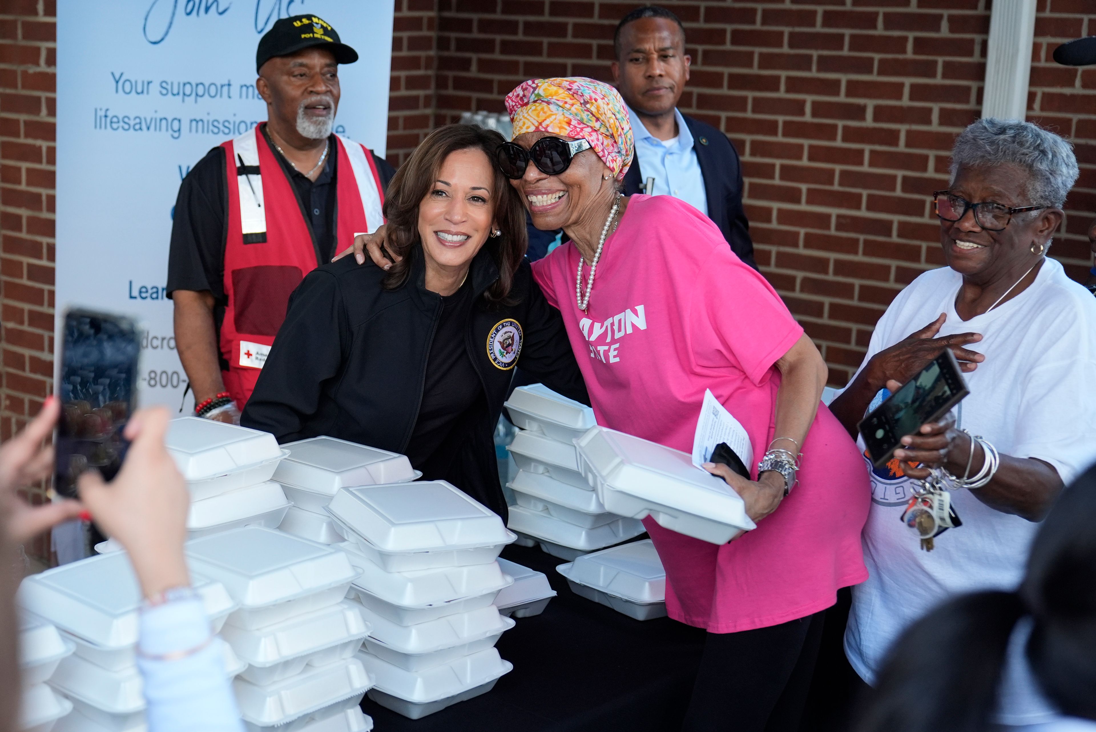 Democratic presidential nominee Vice President Kamala Harris poses for a photo as she helps distribute food with the American Red Cross at the Henry Brigham Community Center in Augusta, Ga., Wednesday, Oct. 2, 2024. (AP Photo/Carolyn Kaster)