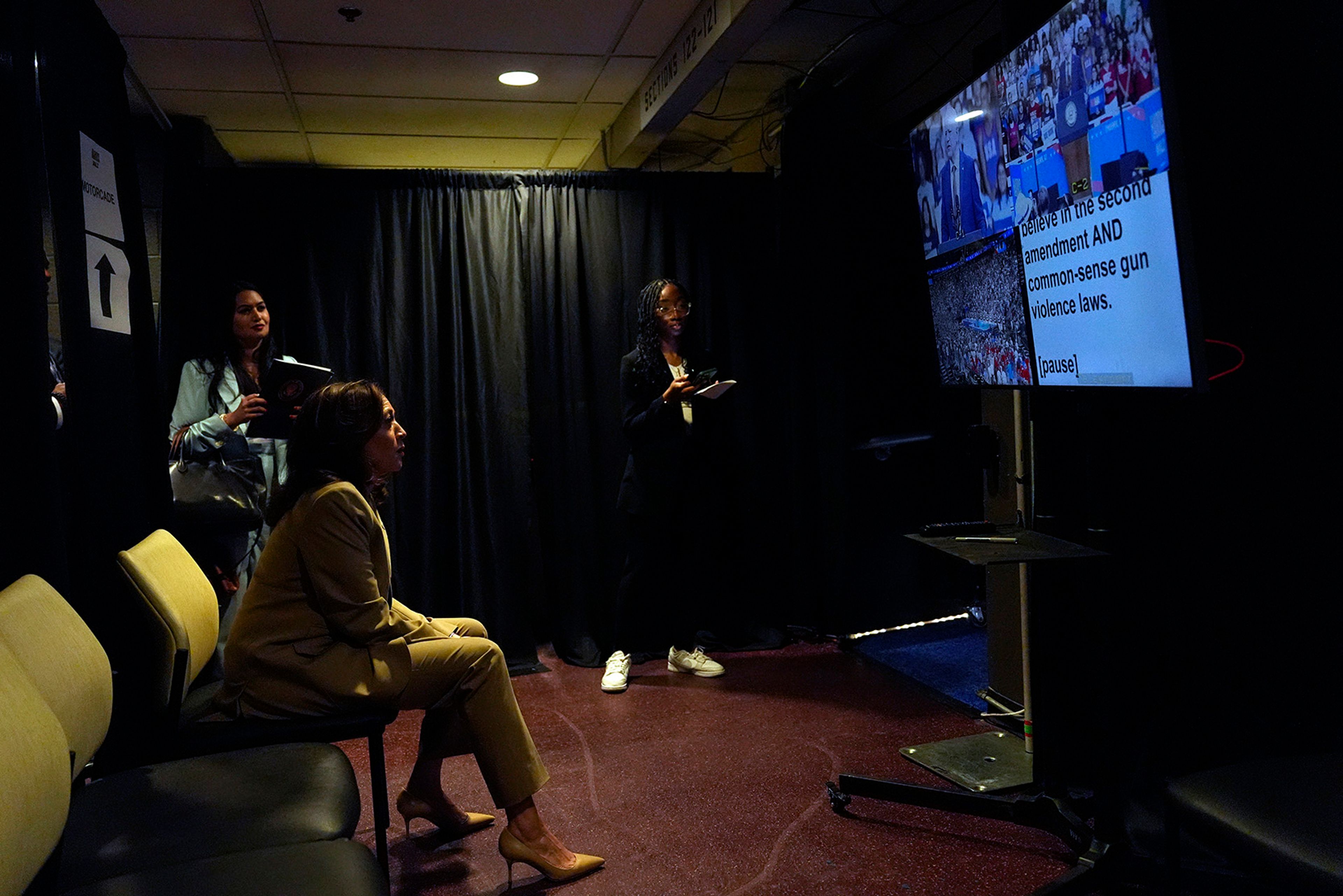 Democratic presidential nominee Vice President Kamala Harris sits backstage as she listens to running mate Minnesota Gov. Tim Walz speak at a campaign rally at Desert Diamond Arena, Friday, Aug. 9, 2024, in Glendale, Ariz. 