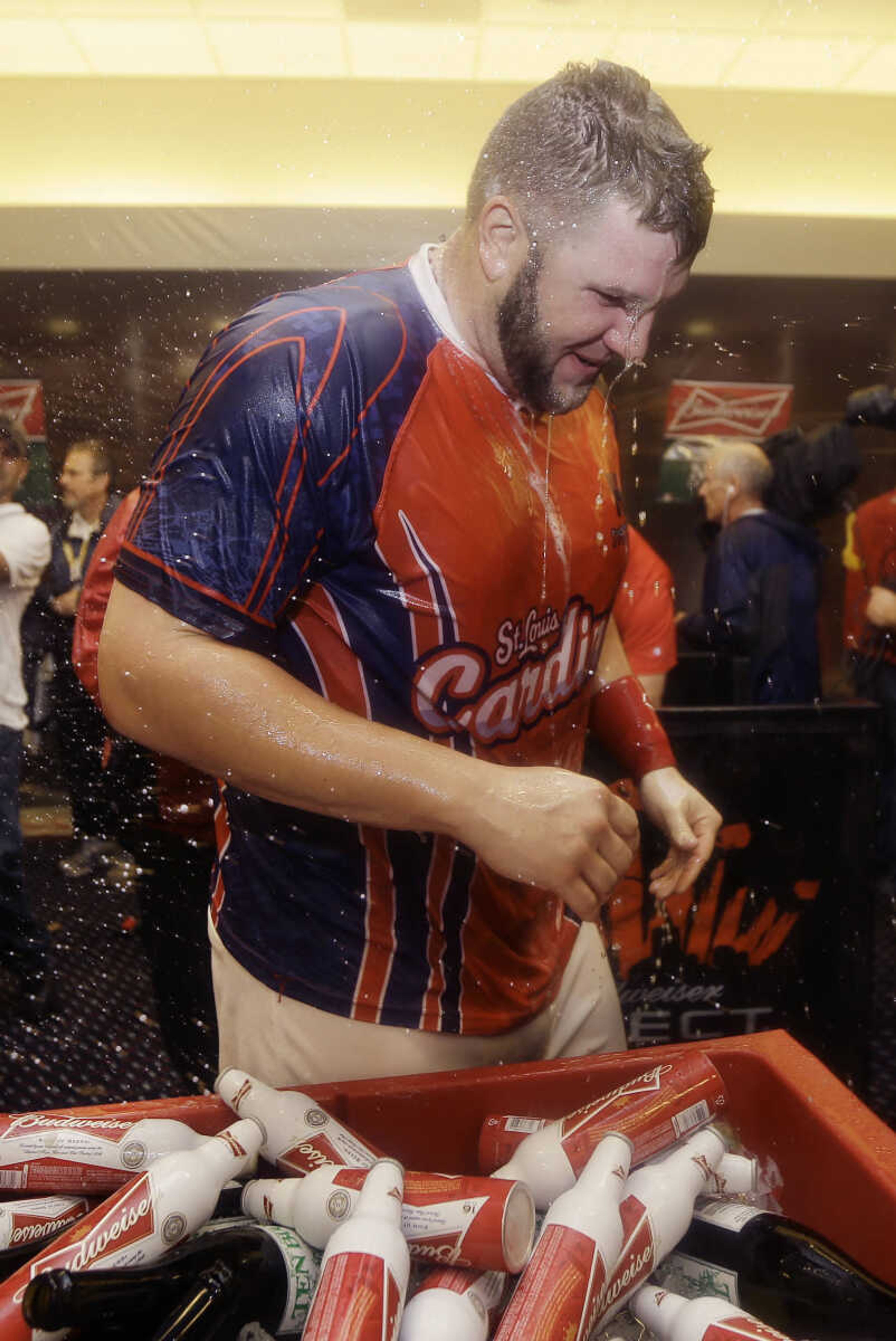 St. Louis Cardinals' Matt Adams stands in the clubhouse after the Cardinals defeated the Pittsburgh Pirates 6-1 in Game 5 of a National League baseball division series, Wednesday, Oct. 9, 2013, in St. Louis. The Cardinals advanced to the NL championship series against the Los Angeles Dodgers. (AP Photo/Jeff Roberson)