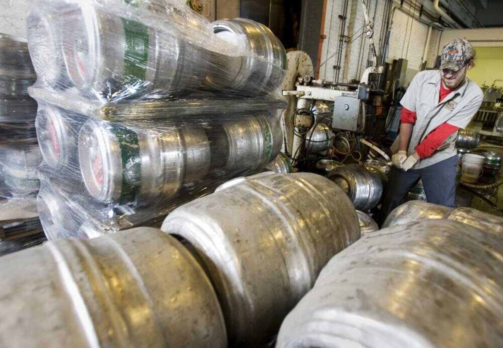 Chad Scheridan washes out some empty kegs at the Lakefront Brewery,nam Thursday, June 28, 2007, in Milwaukee. With metal prices rising, beer makers say they expect to lose hundreds of thousands of kegs and millions of dollars this year as those stainless steel holders of brew are stolen and sold for scrap. (AP Photo/Morry Gash)