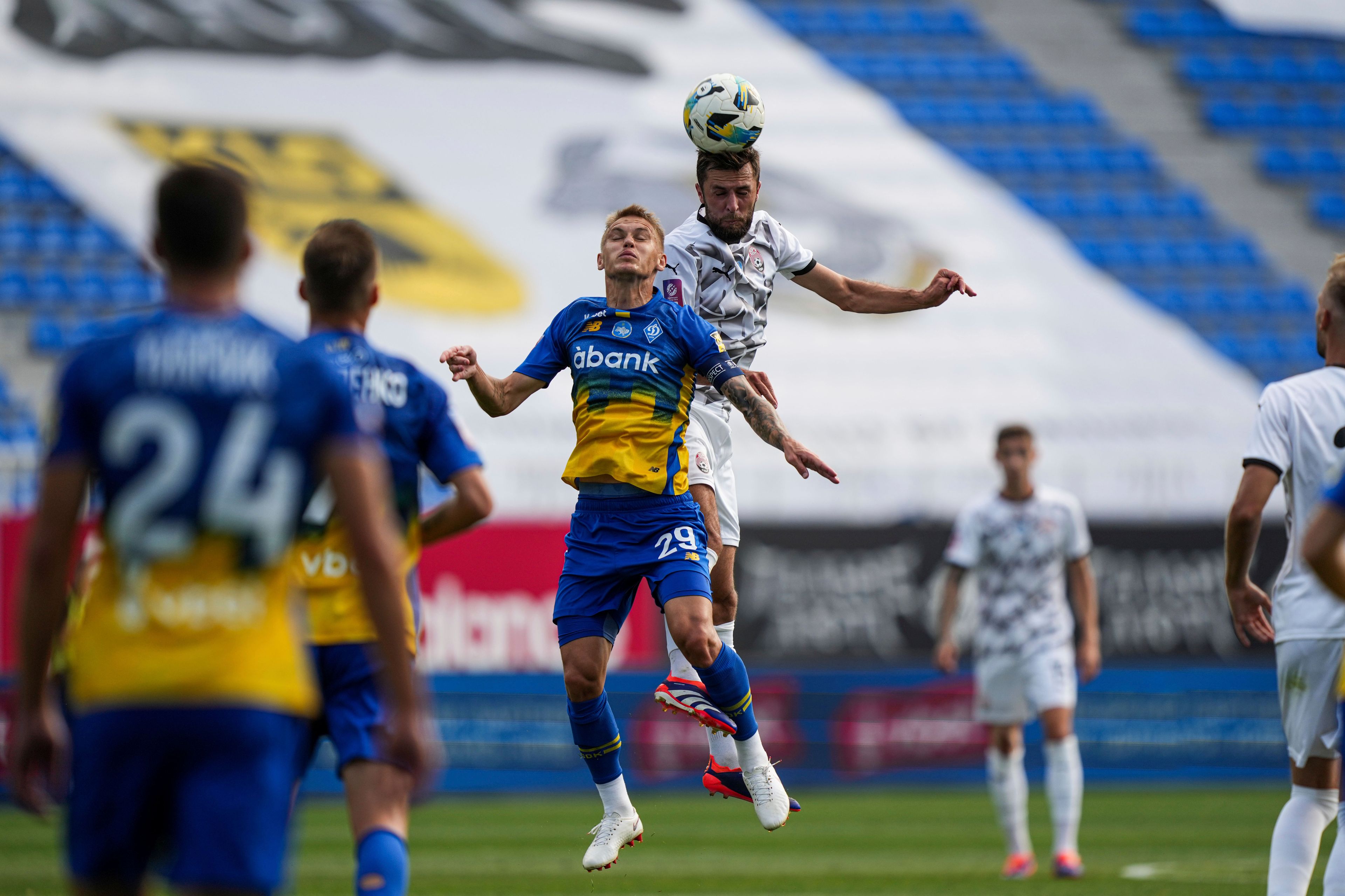 Vitalii Buyalskiy of Dynamo Kyiv and Oleksiy Khakhliyov of Zorya Luhansk, top, compete for the ball as they play a soccer match of Ukrainian Premier League in Kyiv, Ukraine, Saturday Sept. 14, 2024. (AP Photo/Evgeniy Maloletka)