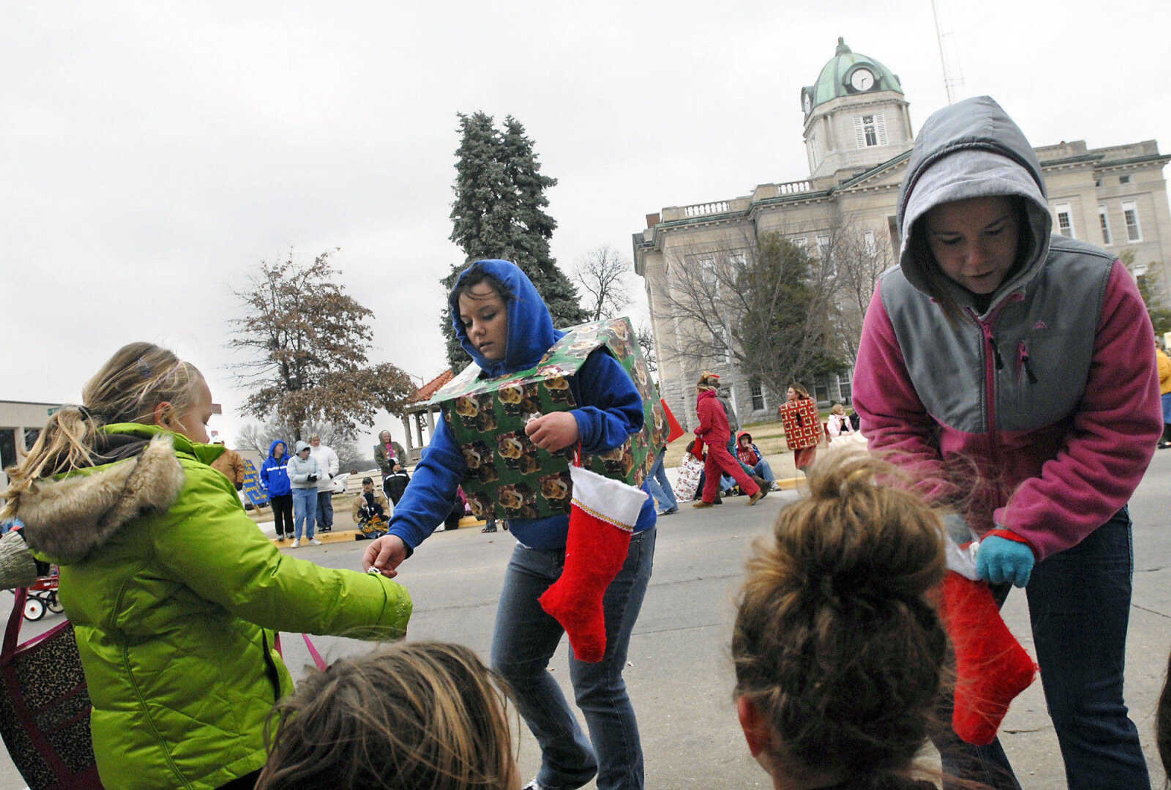 KRISTIN EBERTS ~ keberts@semissourian.com

Breanna Gehlert, left, and Molly Halter, right, members of the Jackson Junior High School FCCLA pass out candy during the Jackson Christmas Parade on Saturday, Dec. 4, 2010, in downtown Jackson.