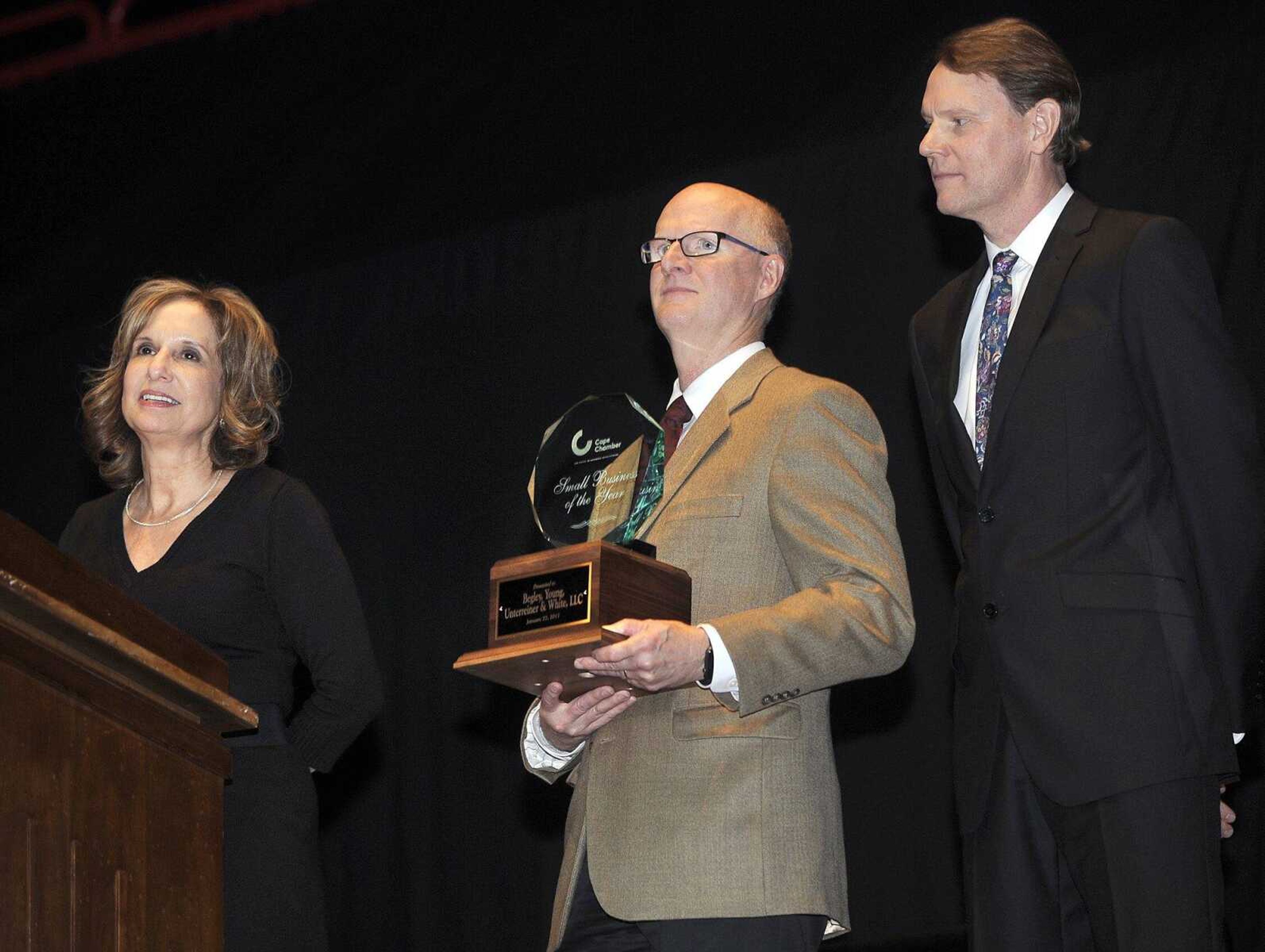 Catherine White, left, Larry Young and Jeff Unterreiner accept a Small Business of the Year Award on behalf of Begley, Young, Unterreiner & White LLC at the Cape Girardeau Area Chamber of Commerce annual dinner Friday at the Show Me Center.