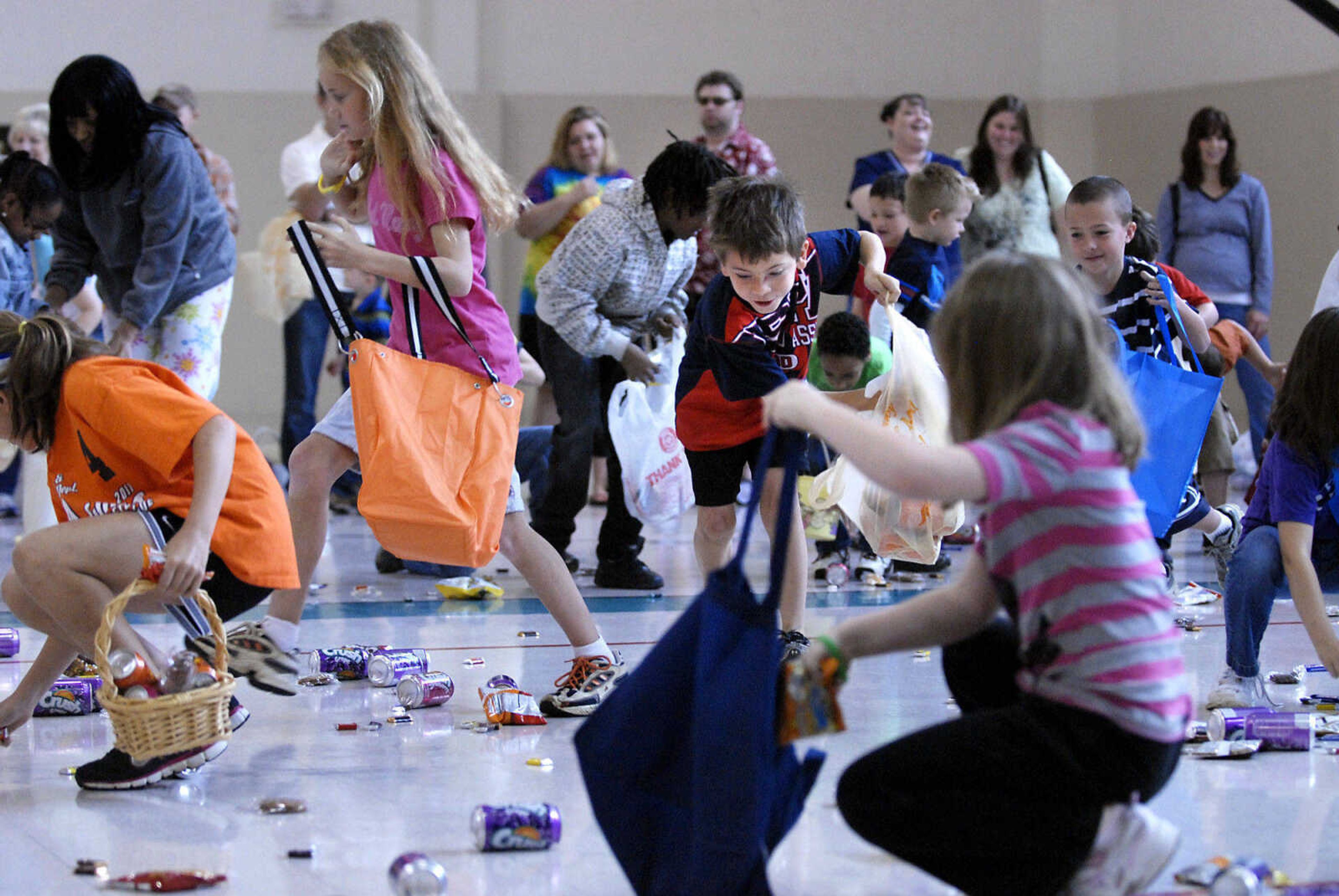 KRISTIN EBERTS ~ keberts@semissourian.com

Kids sweep up goodies during the Schnucks Pepsi Easter egg hunt at the Osage Center on Saturday, April 23, 2011, in Cape Girardeau. Kids ages 2-7 turned out to collect an array of soda, chips, cookies and candy during the hunt.