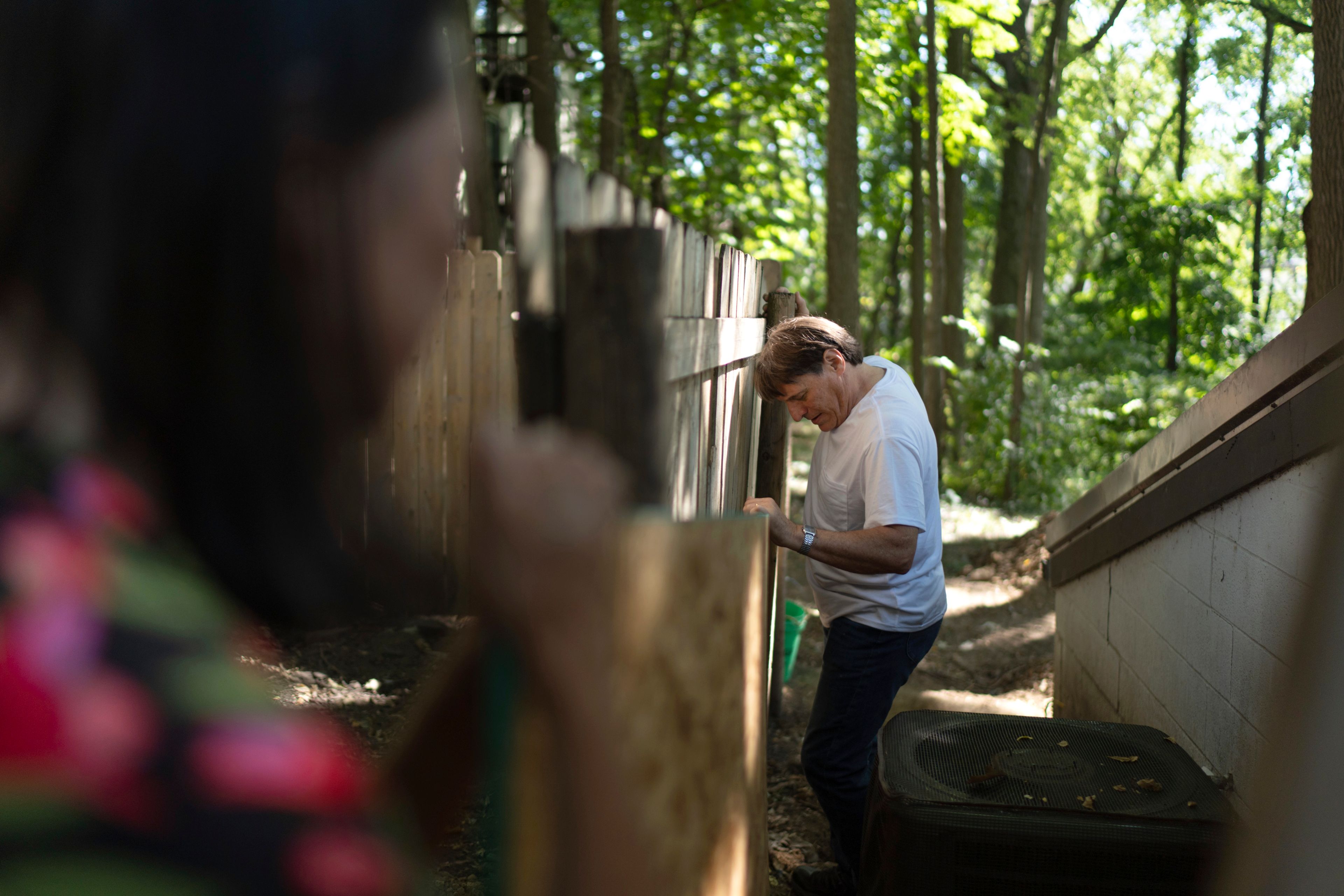 Lesley Dzik, left, helps her husband, Matt, place a sheet of plywood at a renovation job he's doing for a fellow church member in Urbana, Ill., Saturday, Sept. 21, 2024. Acts of kindness bring them together and Matt often does handy-man jobs to help people who can't afford professionals. (AP Photo/David Goldman)