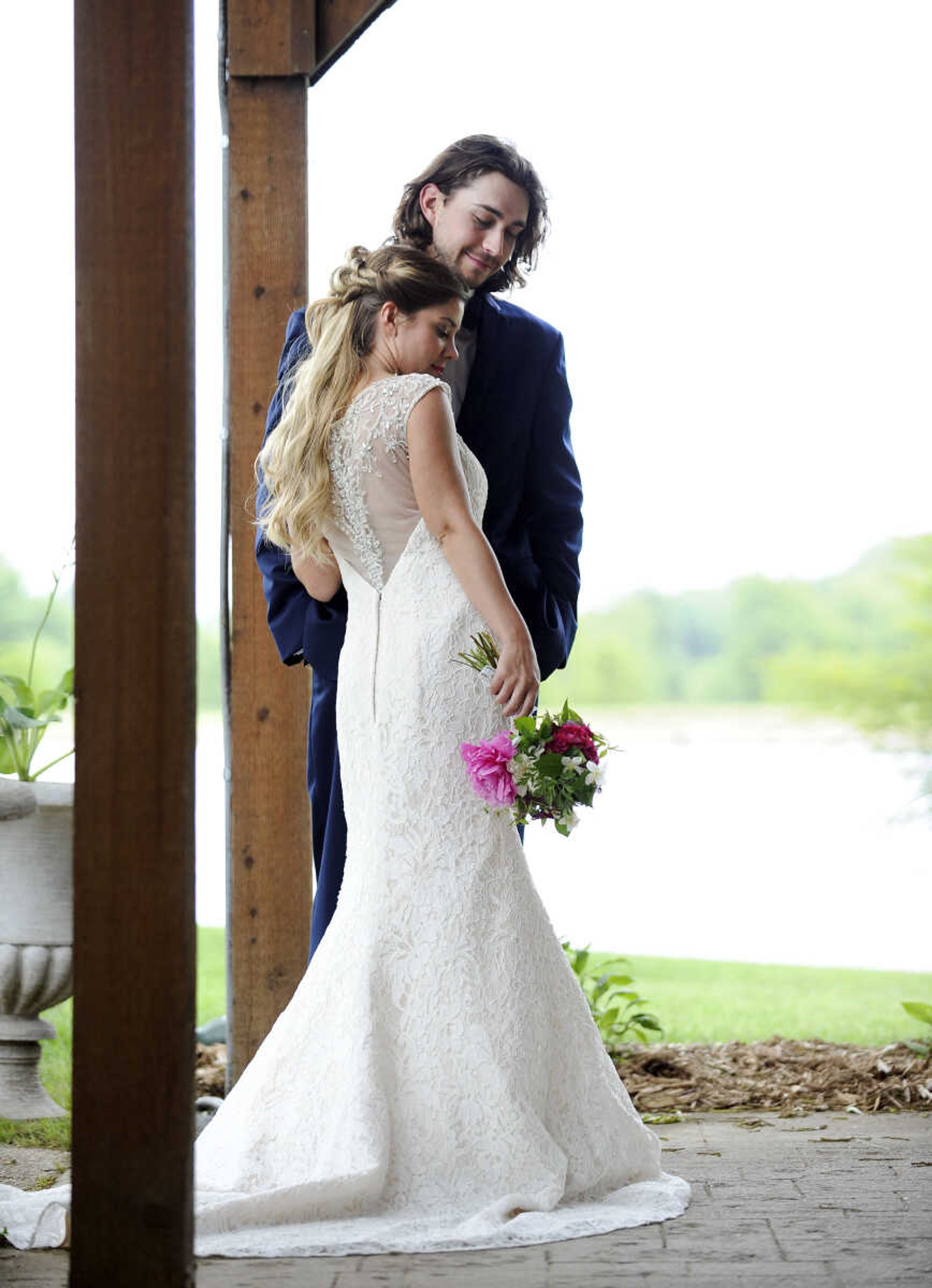 On Lydia:  Alfred Angelo fit-and-flare gown in ivory and champagne lace with crystal and rhinestone buttons adorning a sheer back. Available at Weddings and Parties Complete in Jackson.


On Evan: Navy Sterling slim fit wedding suit by Michael Kors with navy plaid bow tie. Provided by Jim's Formal Wear and available at Garber's Men's Wear in Cape Girardeau.