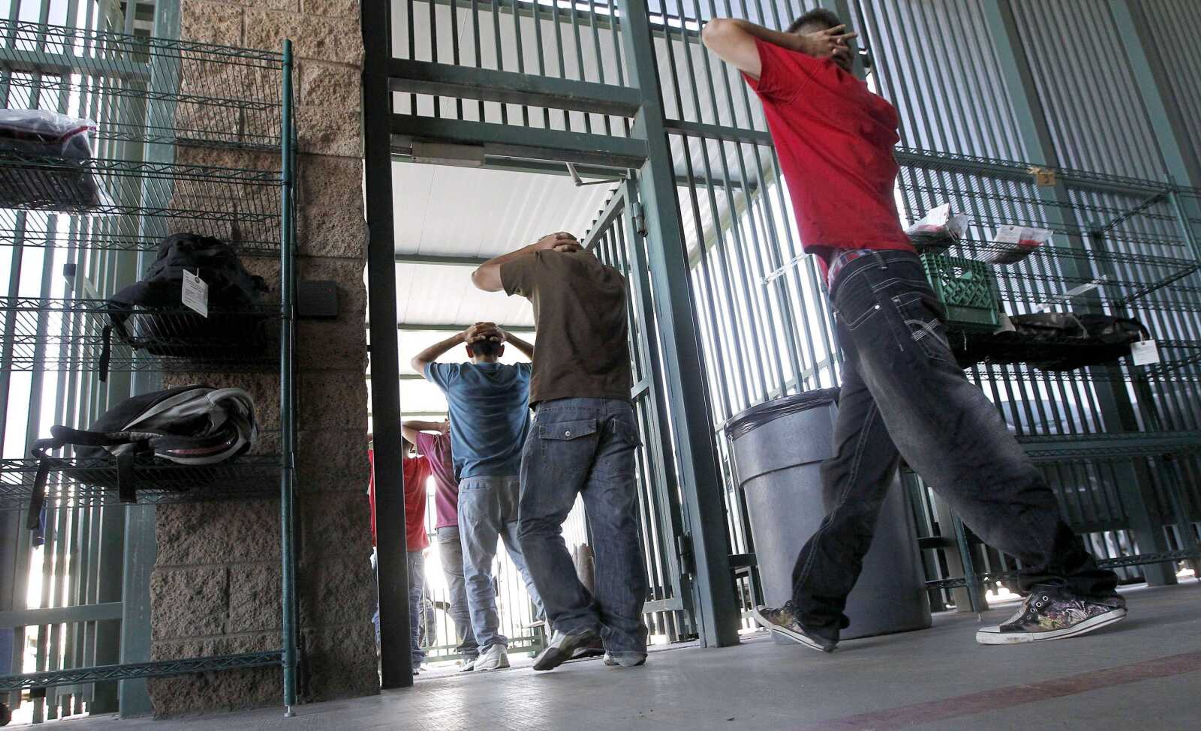 Illegal immigrants prepare to enter a bus after being processed Aug. 9 by the U.S. Border Patrol in Tucson, Ariz. (Ross D. Franklin ~ Associated Press)