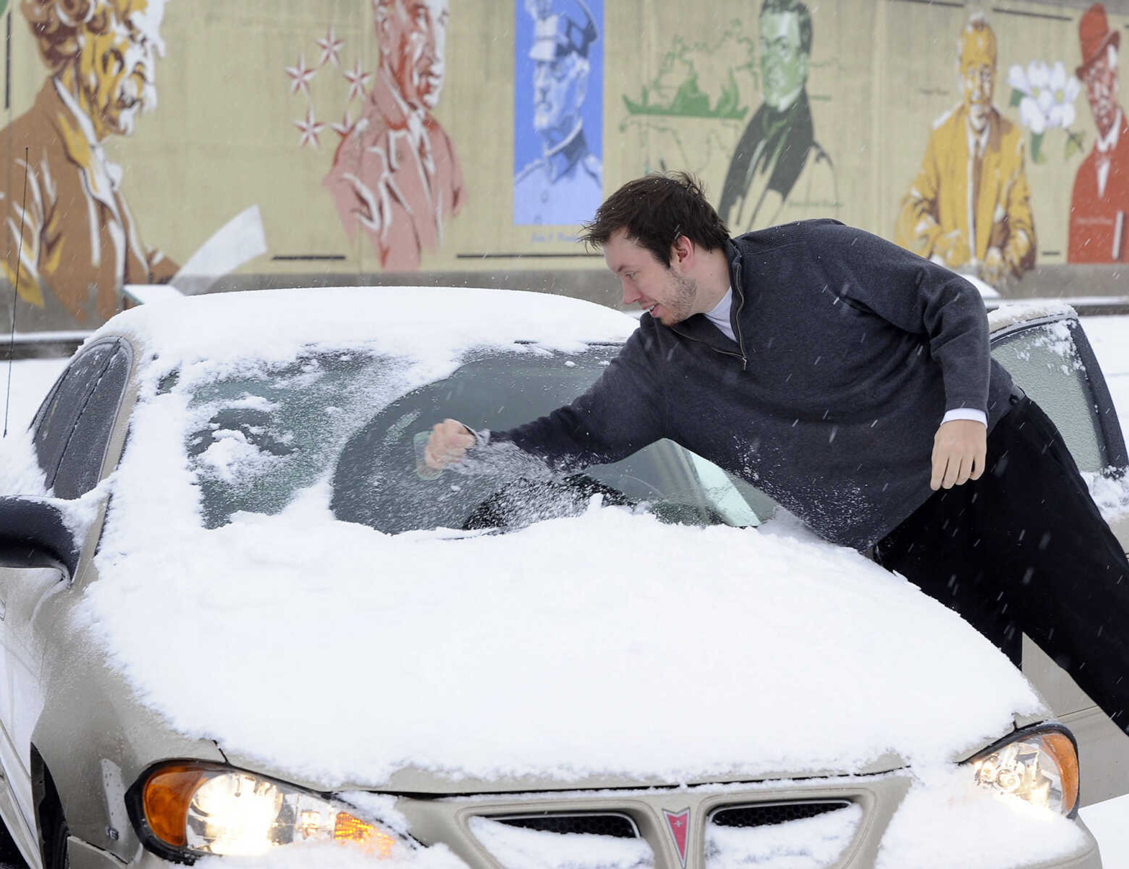 FRED LYNCH ~ flynch@semissourian.com
Pete Bothmann clears ice and snow from his car so he can drive to work Sunday morning, Feb. 14, 2016 in downtown Cape Girardeau. Bothmann said he got two calls from work and agreed to go in to help with an expected increase in pizza deliveries.