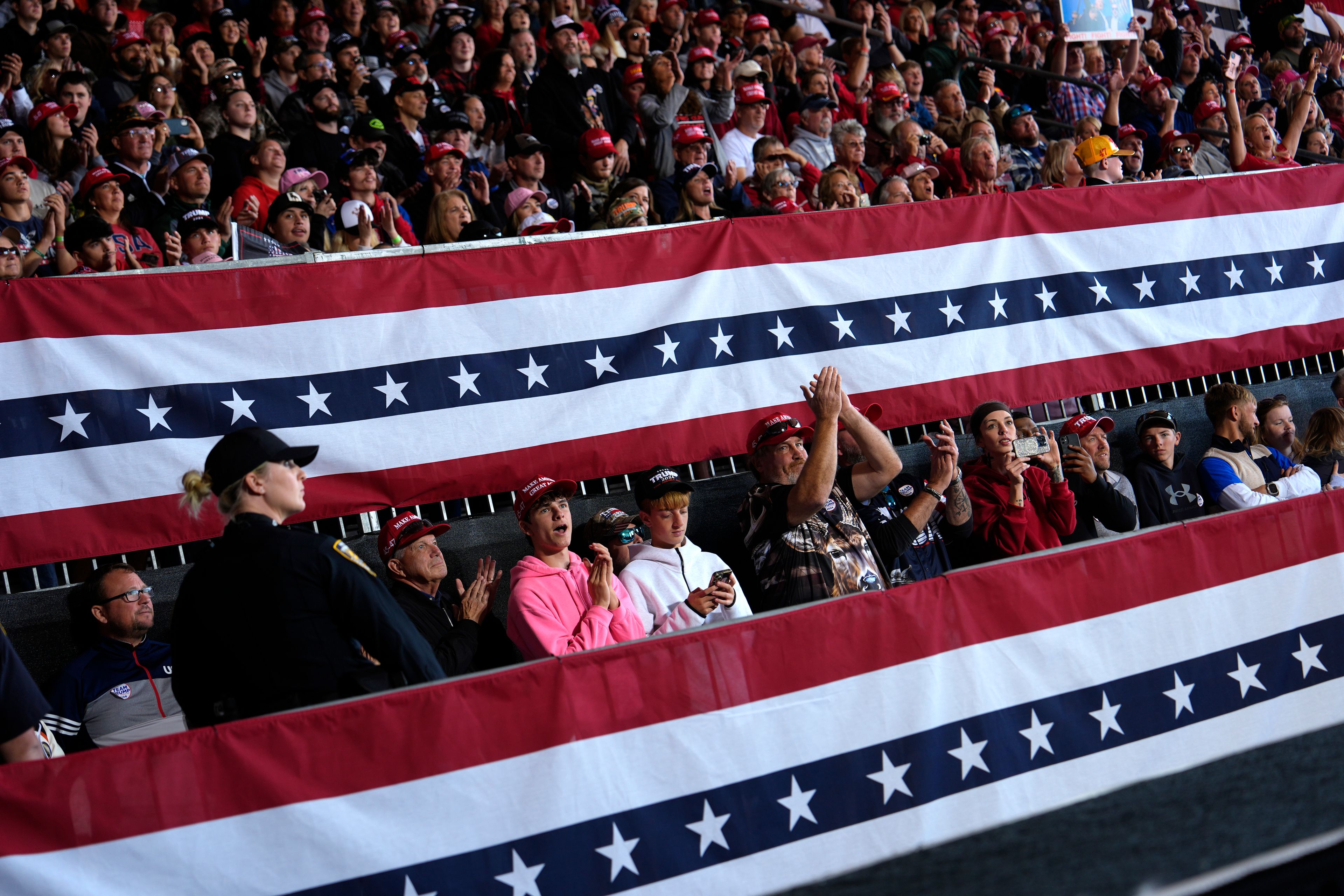 Attendees listen as Republican presidential nominee former President Donald Trump speaks during a campaign rally at Dodge County Airport, Sunday, Oct. 6, 2024, in Juneau, Wis. (AP Photo/Julia Demaree Nikhinson)