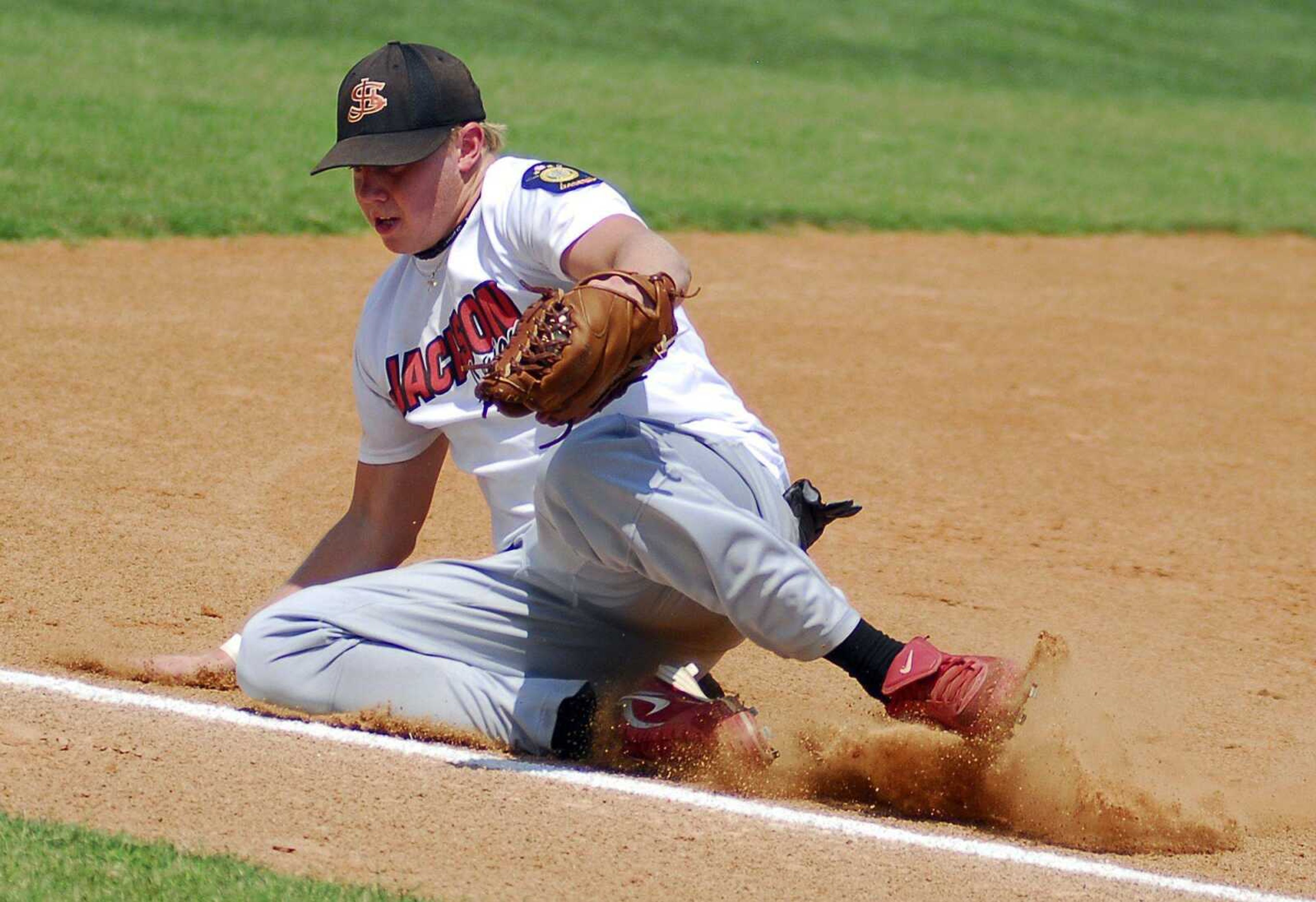 Jackson's Kyle Reynolds scoops a ground ball during Saturday's district tournament game against Poplar Bluff at Notre Dame Regional High School. (Laura Simon)