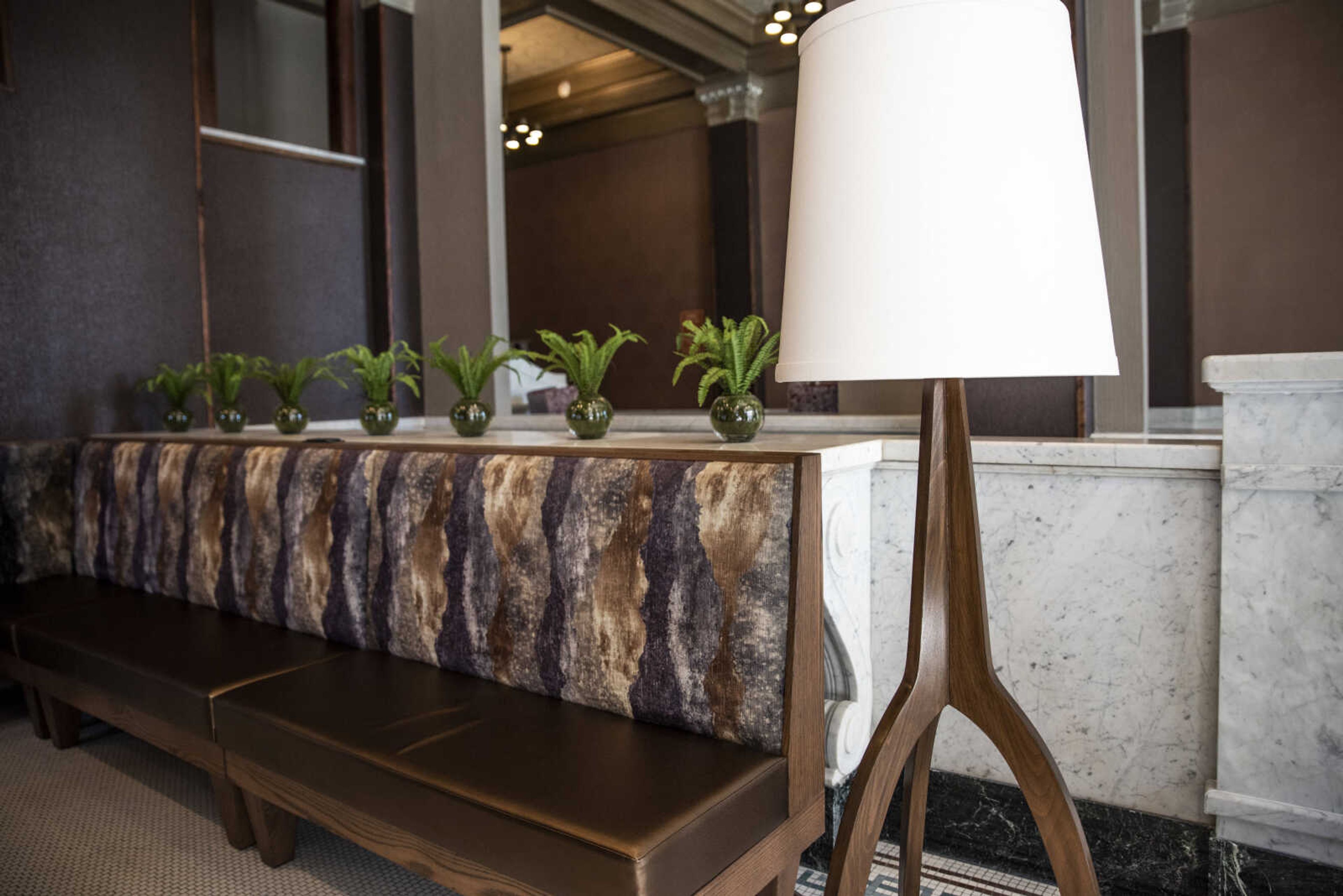 Potted plants sit on the restored former bank counter in the front lobby of the new Courtyard by Marriott hotel in Downtown Cape Monday, Oct. 29, 2018, in Cape Girardeau.