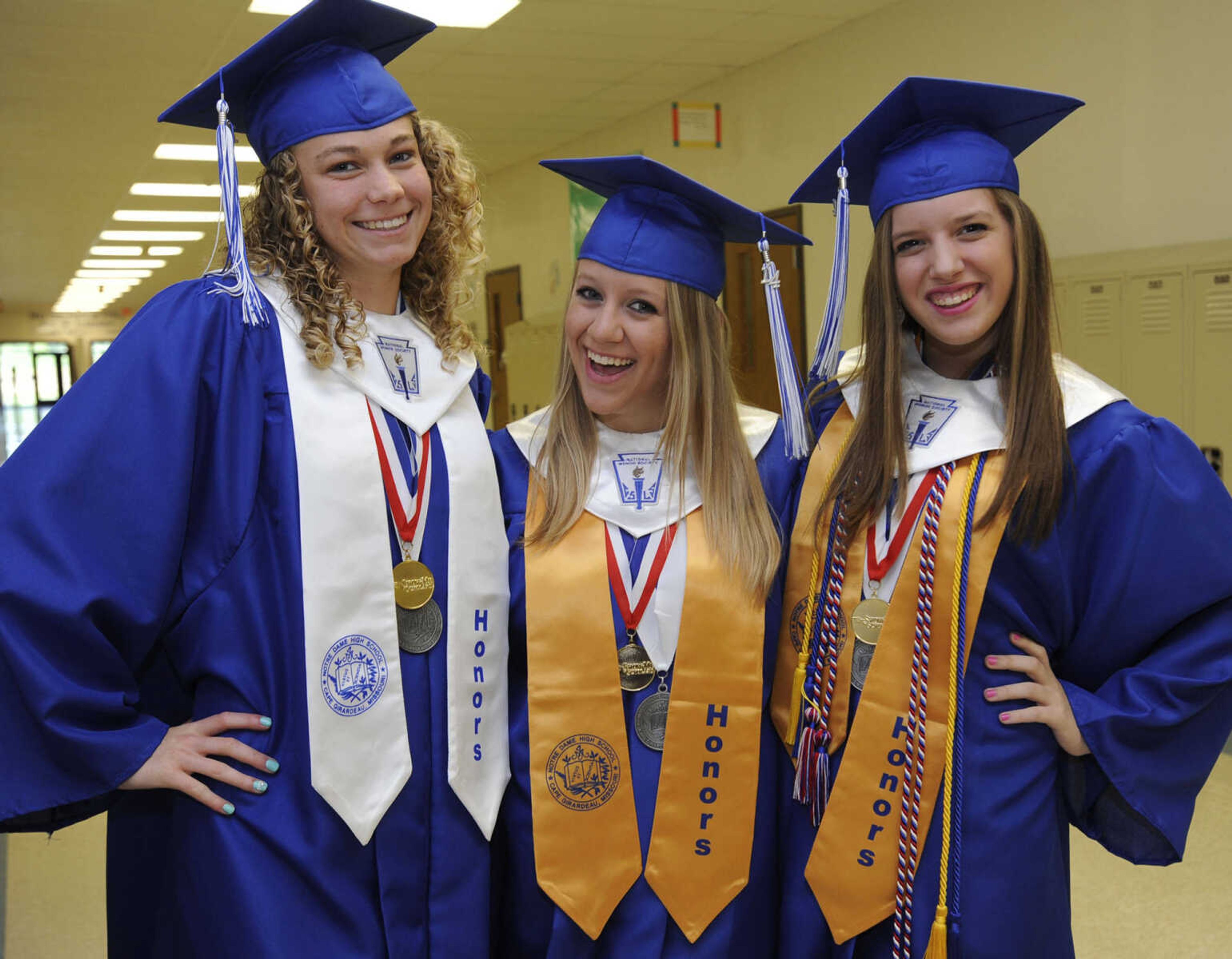 Crystal Caragine, left, Megan Schmittzehe and Becky Earley pose for a photo at the Notre Dame Regional High School commencement Sunday, May 18, 2014.