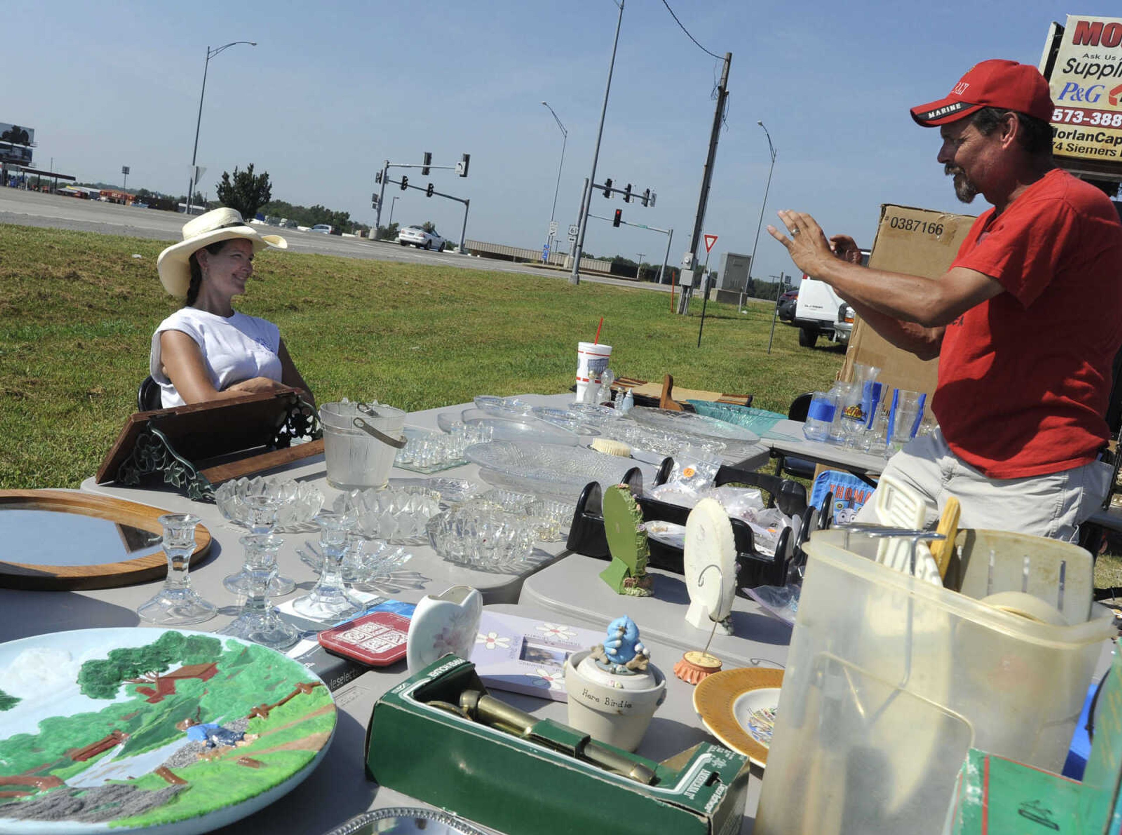 Tony LaForest, co-owner of JCT Antiques and Collectibles, takes a picture of vendor Ashley Gilbert of Jackson during the Highway 61 Yard Sale Saturday, Aug. 31, 2013 in Fruitland.