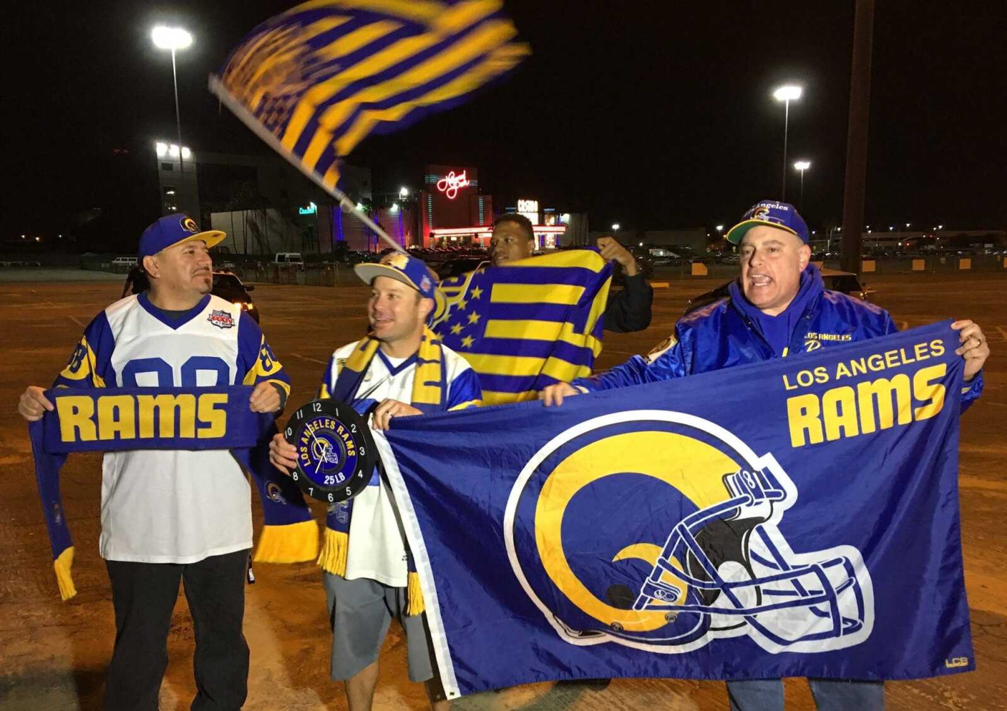 Football fans cheer Tuesday for the return of the Rams to Los Angeles on the site of the old Hollywood Park horse-racing track in Inglewood, California. NFL owners voted Tuesday night to allow the St. Louis Rams to move to a new stadium at the site just outside Los Angeles, and the San Diego Chargers will have an option to share the facility. (AP Photo/Damian Dovarganes)