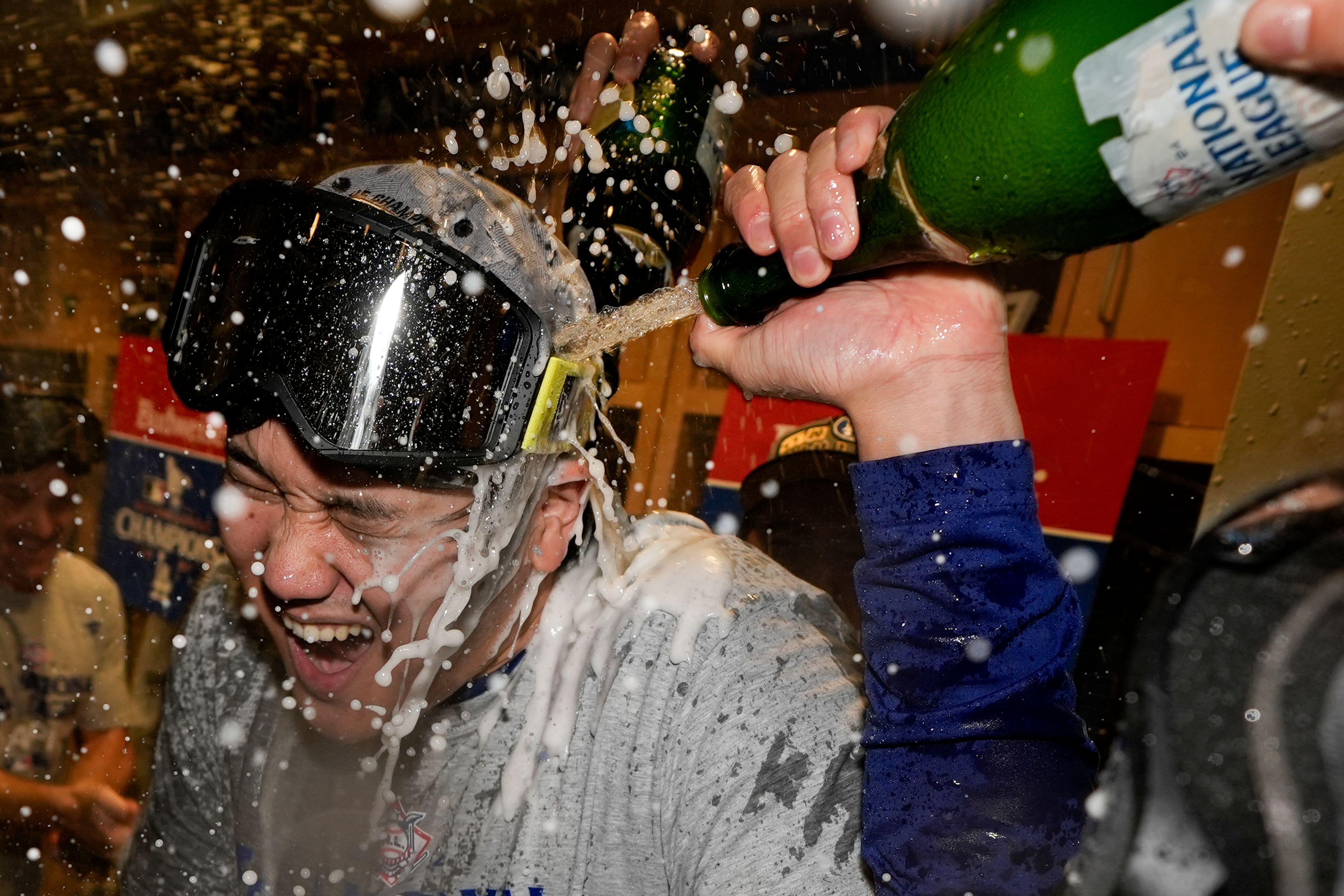 Los Angeles Dodgers Shohei Ohtani celebrates in the locker room after their win against the New York Mets in Game 6 of a baseball NL Championship Series, Sunday, Oct. 20, 2024, in Los Angeles. (AP Photo/Ashley Landis)