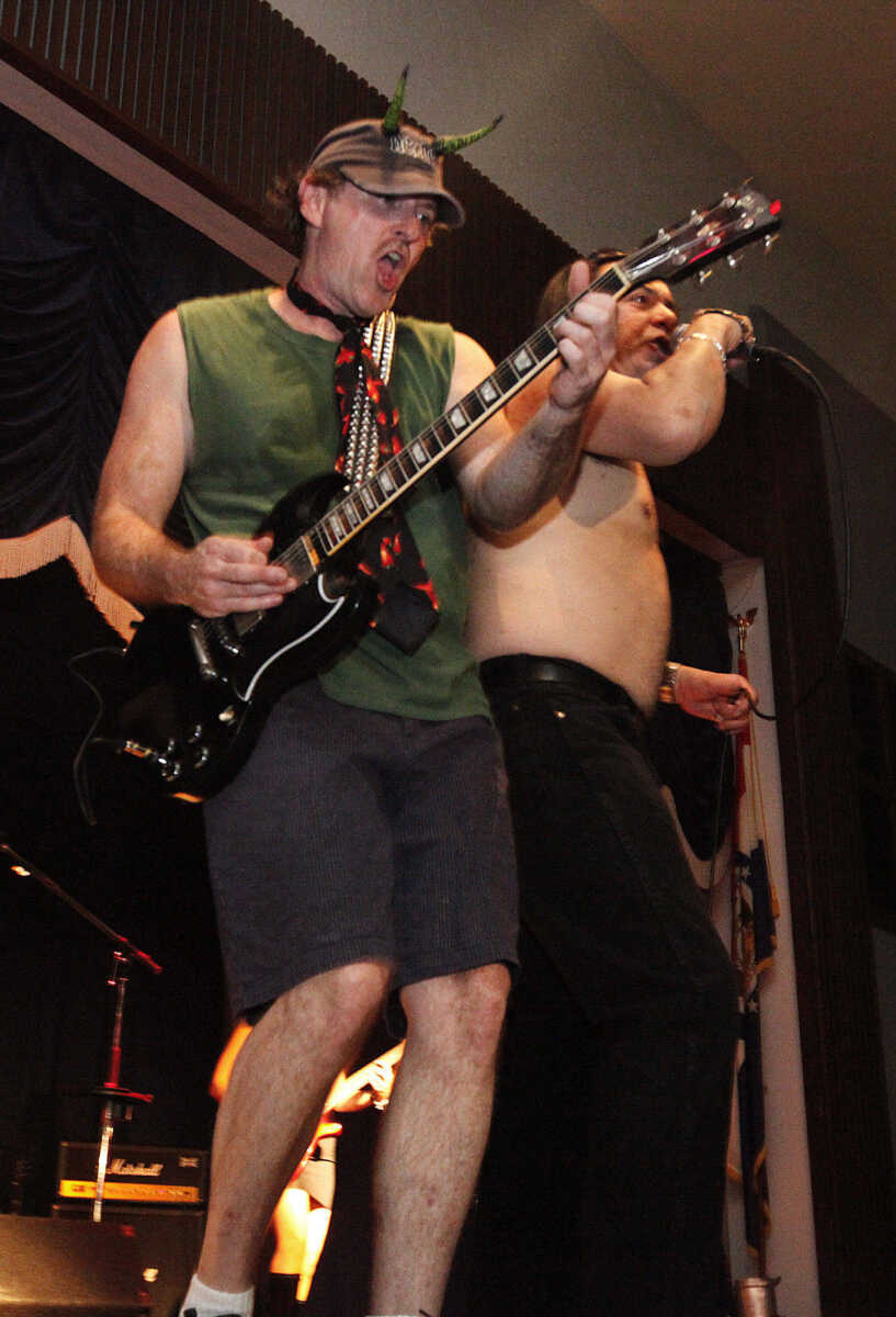 CHRIS MACKLER ~ photos@semissourian.com

Basest Jaime Doxsey and singer David Llano of Dirty Deeds, a tribute to AC/DC, perform during the Kiss, AC/DC and Rod Stewart Tribute Concert held at the Arena Building on Saturday, Nov. 6, 2010, in Cape Girardeau.