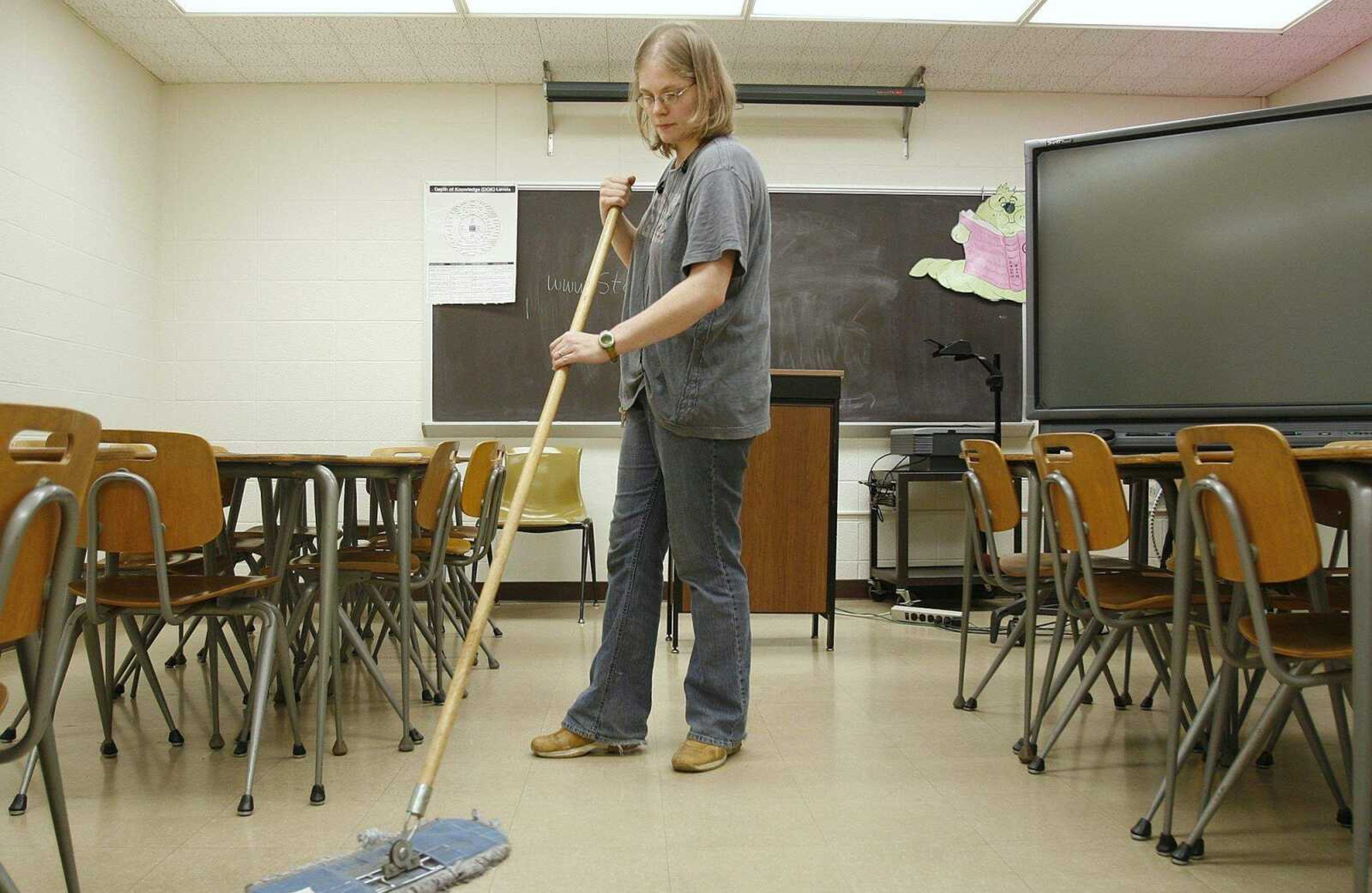 ELIZABETH DODD ~ edodd@semissourian.com
Marissa Benn, of Cape Girardeau, sweeps a classroom in the Scully Building on the Southeast Missouri State University campus Wednesday. Benn tidies classrooms typically from 4p.m. to midnight and said a lot of her family members also work for Southeast Missouri.