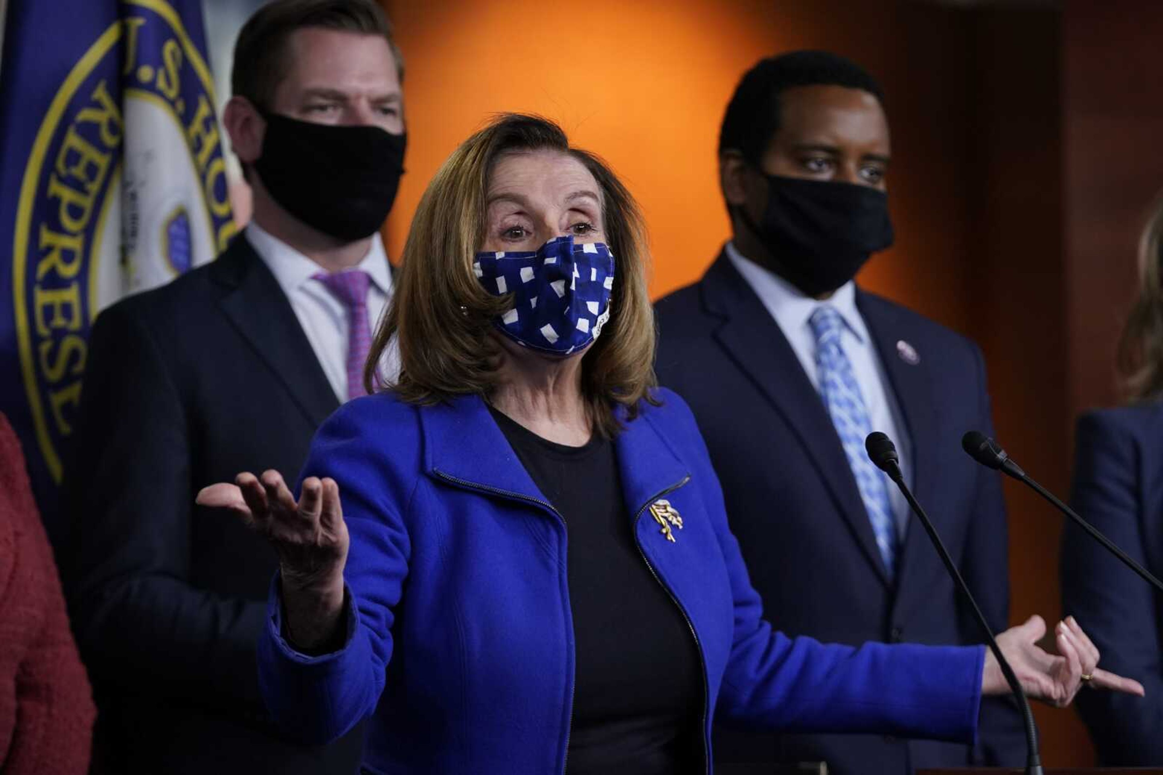 House Speaker Nancy Pelosi of California, with impeachment managers Rep. Eric Swalwell, D-Calif., and Rep. Joe Neguse, D-Colo., speaks to members of the media during a news conference Saturday on Capitol Hill in Washington, after the U.S. Senate voted to acquit former President Donald Trump of inciting riot at U.S. Capitol.