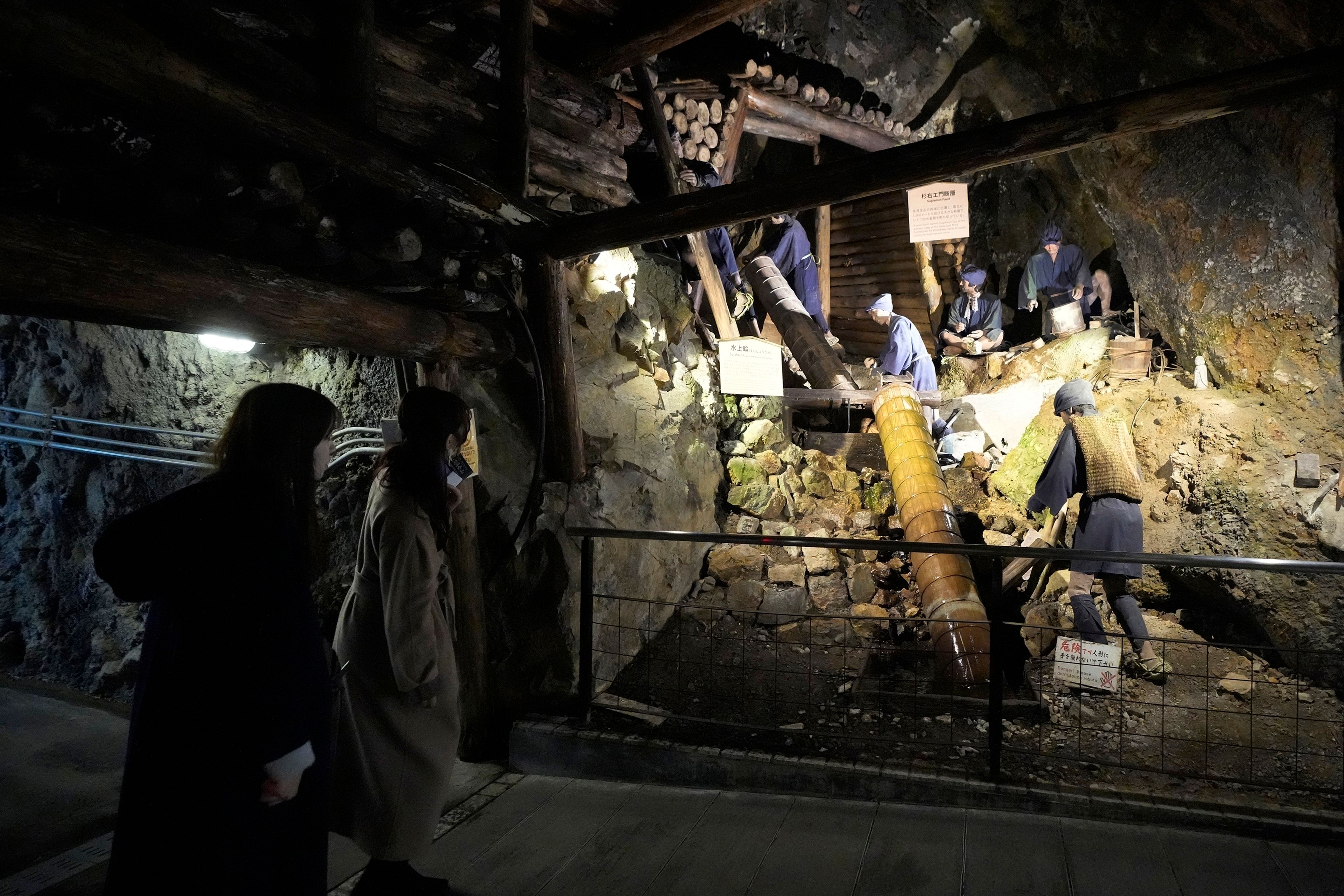 Visitors look at display at Sado Kinzan Gold Mine historic site in Sado, Niigata prefecture, Japan, Saturday, Nov. 23, 2024. (AP Photo/Eugene Hoshiko)