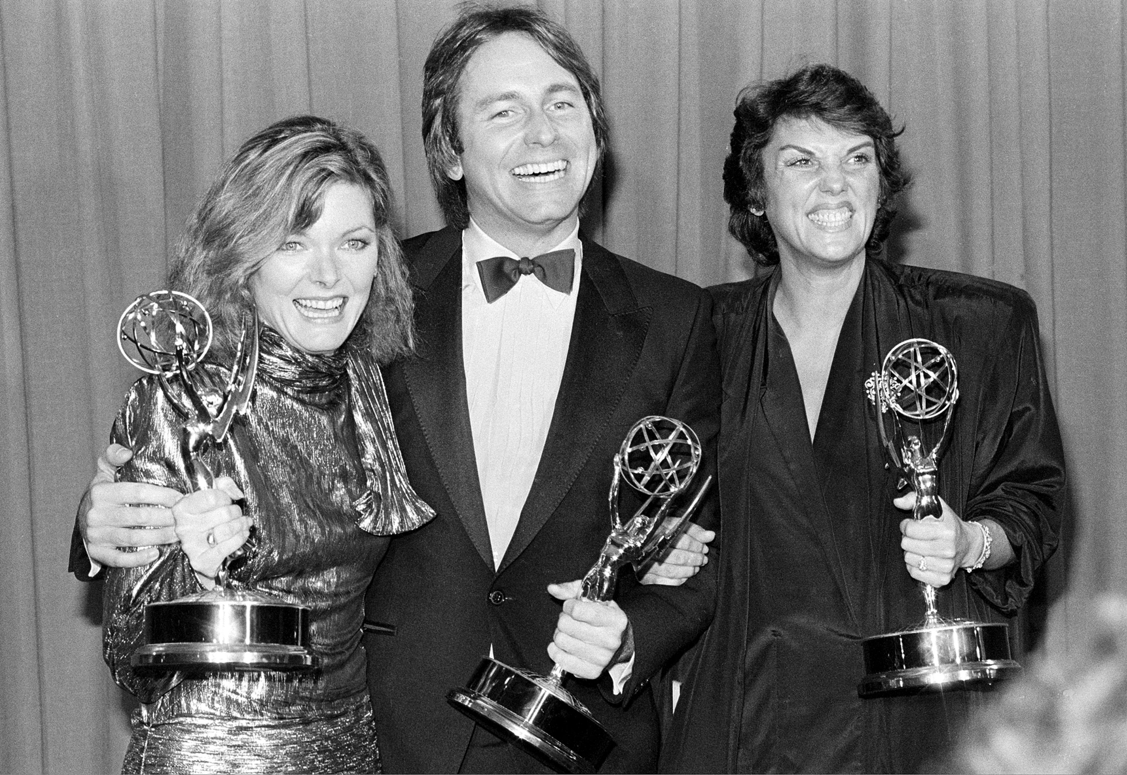 FILE - Emmy winners, from left, Jane Curtin, John Ritter, and Tyne Daly pose backstage at the Emmy Awards presentation at the Pasadena Civic Auditorium in Pasadena, Ca., Sept. 23, 1984. Curtin won for best actress in a comedy series for "Kate and Allie"; Ritter was named outstanding actor in a comedy series for his role in "Three's Company"; and Daly won for best actress in a dramatic series for "Cagney and Lacey." (AP Photo, File)