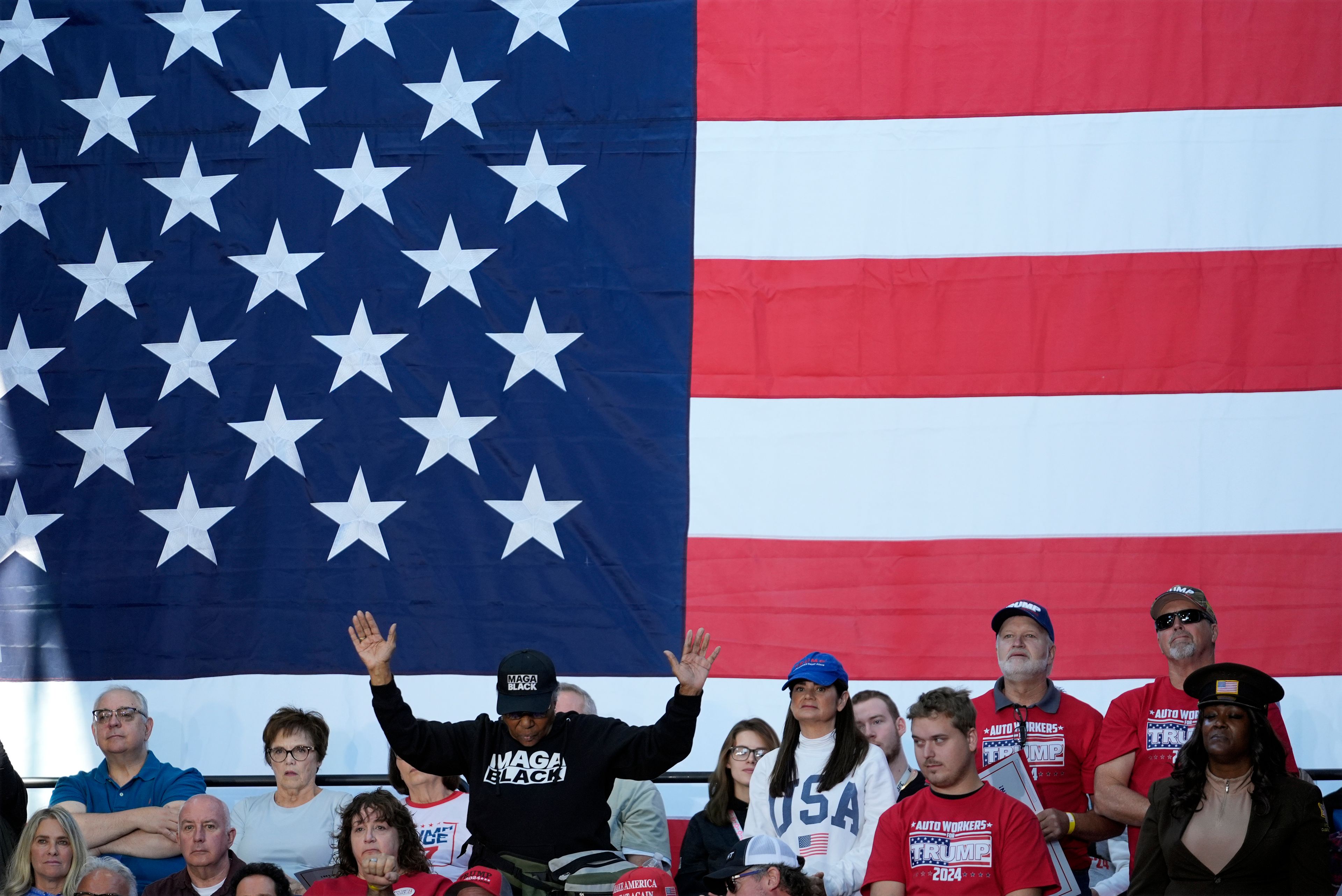 Supporters pray before Republican vice presidential nominee Sen. JD Vance, R-Ohio speaks at a campaign event Eastern Market Tuesday, Oct. 8, 2024, in Detroit. (AP Photo/Paul Sancya)