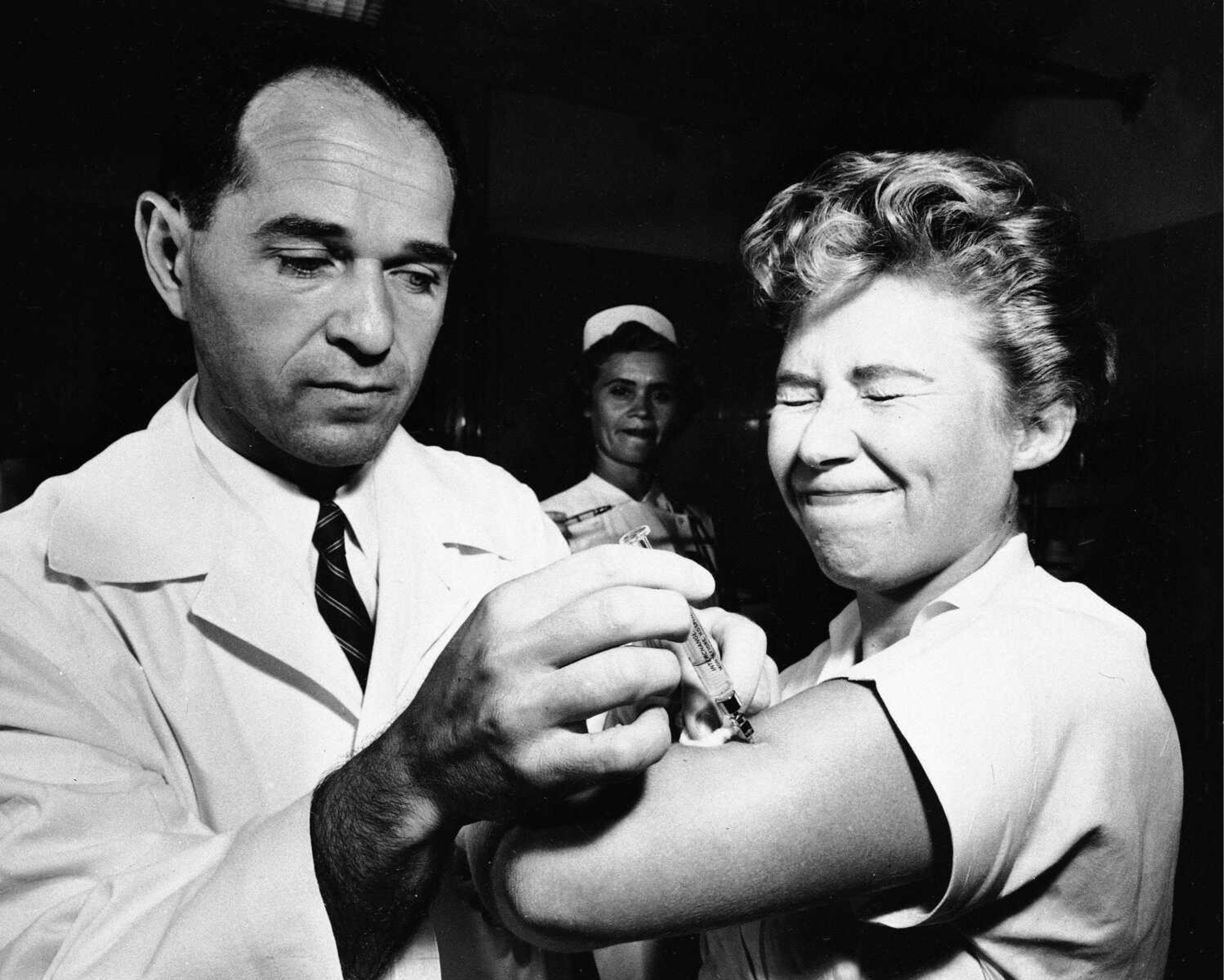 This Aug. 16, 1957, photo shows Dr. Joseph Ballinger giving Marjorie Hill, a nurse at Montefiore Hospital in New York, the first Asian flu vaccine shot to be administered in New York. U.S. health officials say swine flu could strike up to 40 percent of Americans over the next two years and as many as several hundred thousand could die if a vaccine campaign and other measures aren't successful. The infection estimates are based on a flu pandemic from 1957, which killed nearly 70,000 in the United States but was not as severe as the infamous Spanish flu pandemic of 1918-1919. (Associated Press file)