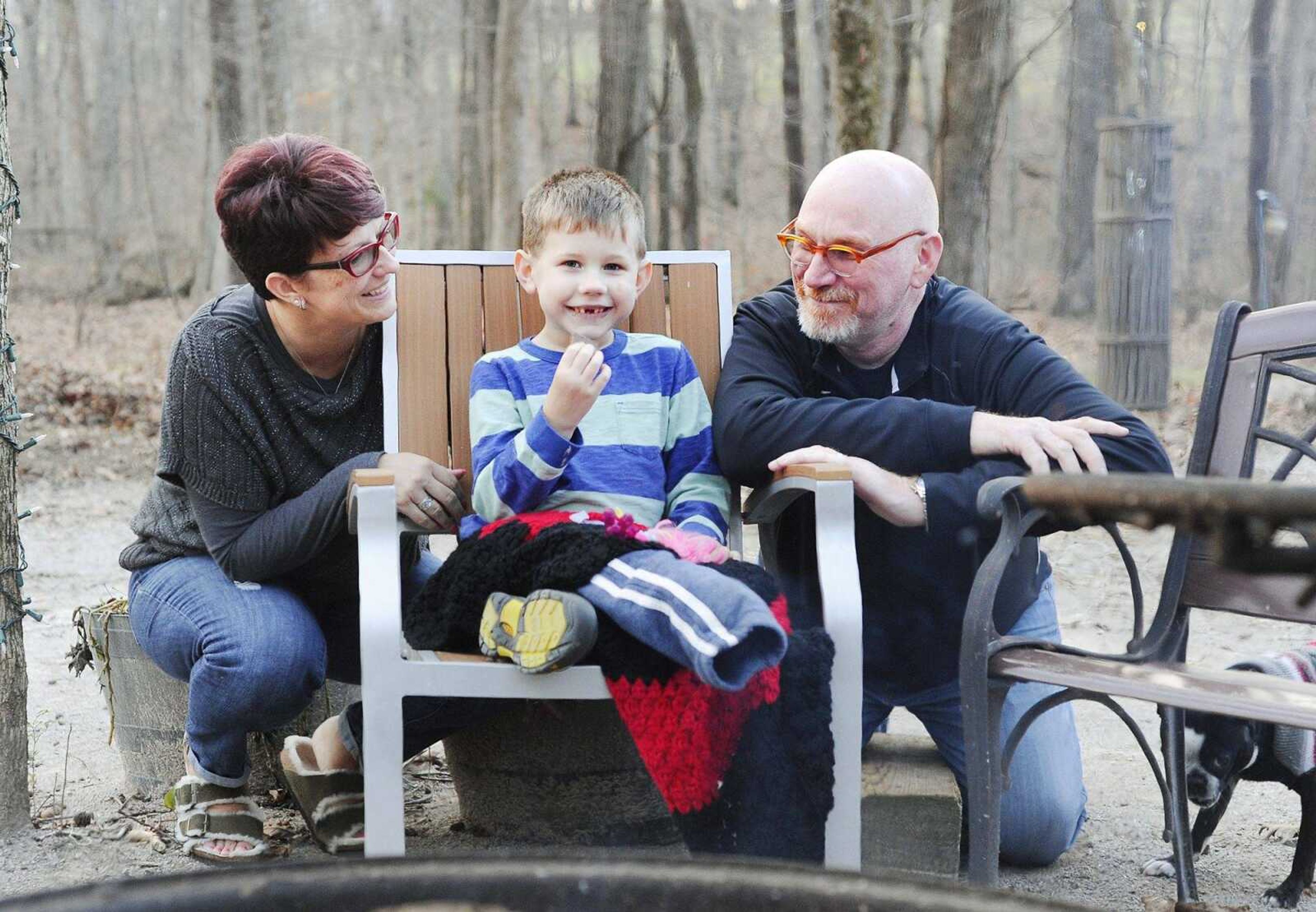 Declan Stevens munches on the chocolate from a s'more Tuesday while surrounded by his parents, Vanessa and Brian. (Laura Simon)