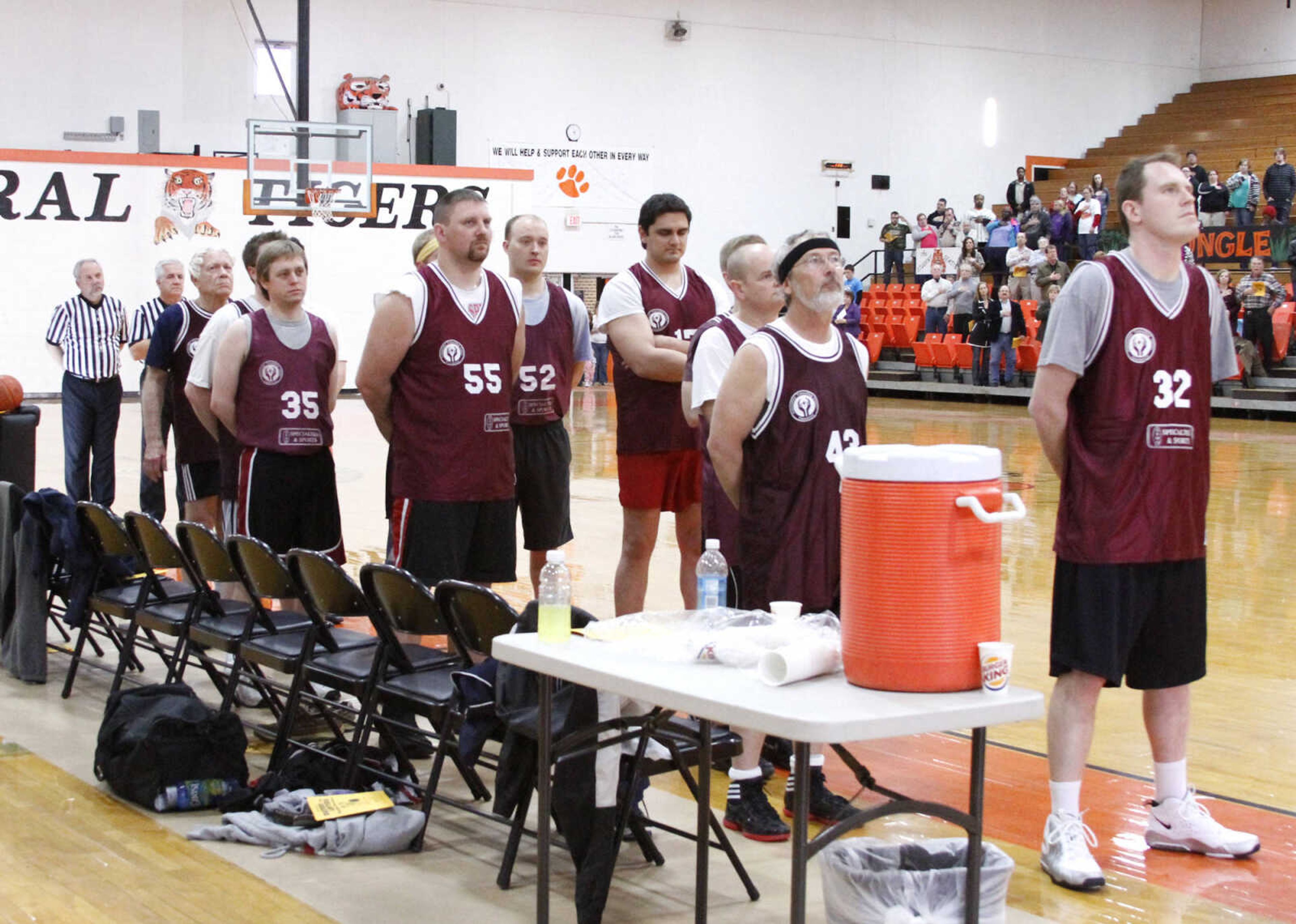 JONATHAN BRIDGES ~ photos@semissourian.com
Lawyers stand at attention for the National Anthem. Saturday, March 3, 3012 during the 19th annual Doctors vs. Lawyers basketball showdown at Cape Central Junior High School in Cape Girardeau. Doctors won 84-70.