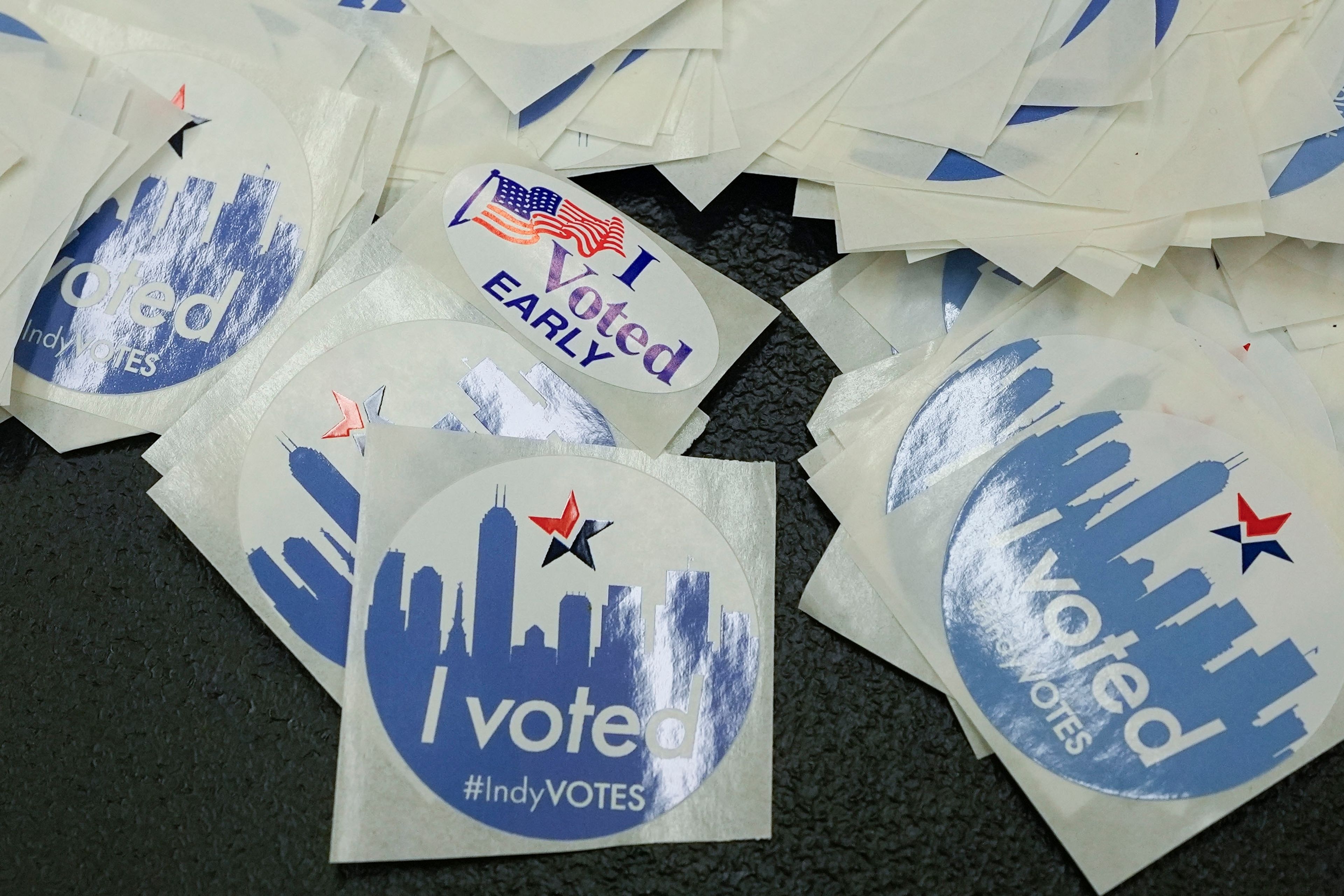 Voting stickers are displayed on a table during in-person absentee voting at the City-County Building, Tuesday, Oct. 8, 2024, in Indianapolis. (AP Photo/Darron Cummings)